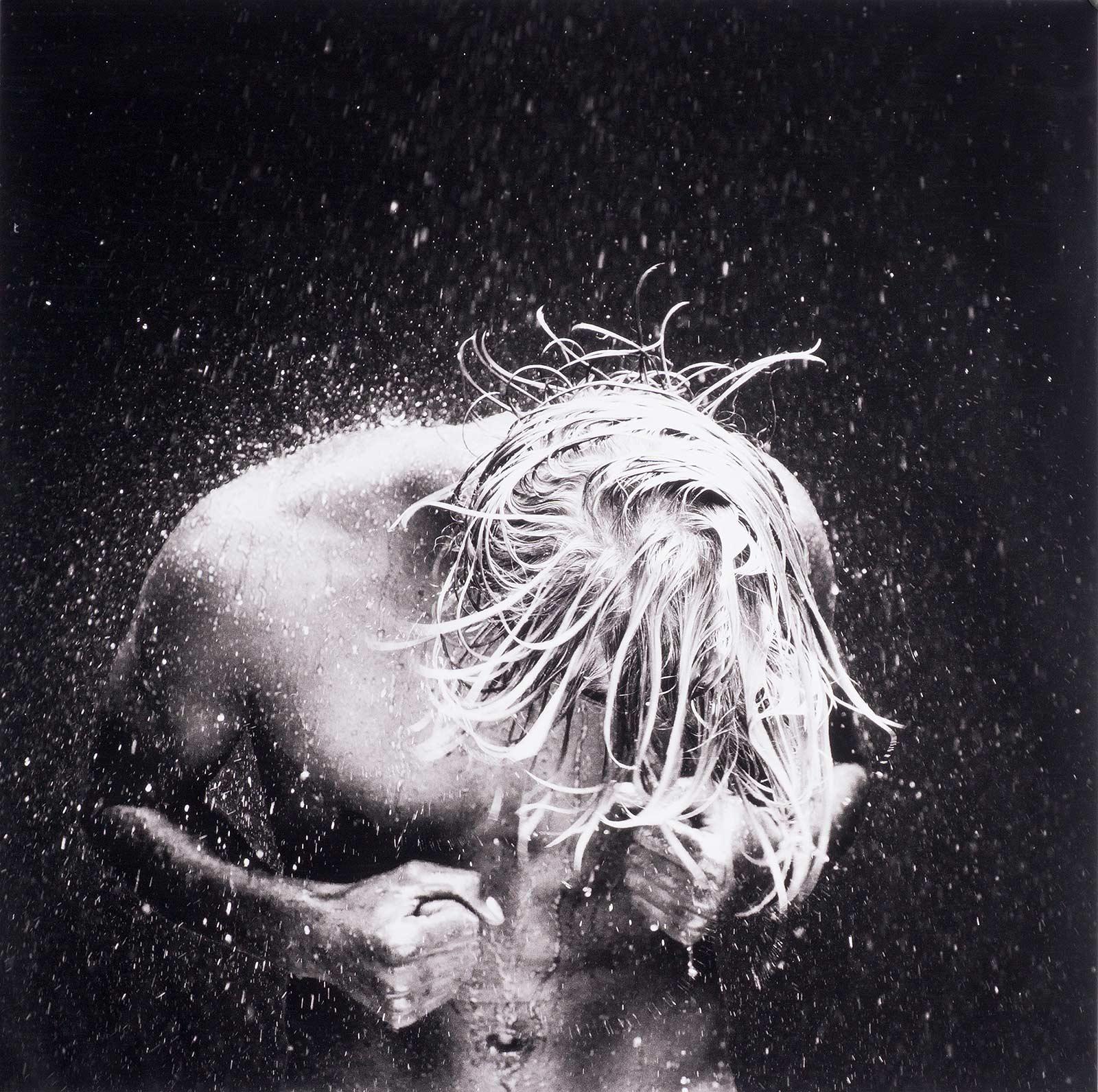 Benno Thoma Black and White Photograph - WET 40 (young nude Dutch boy being doused by droplets of water)