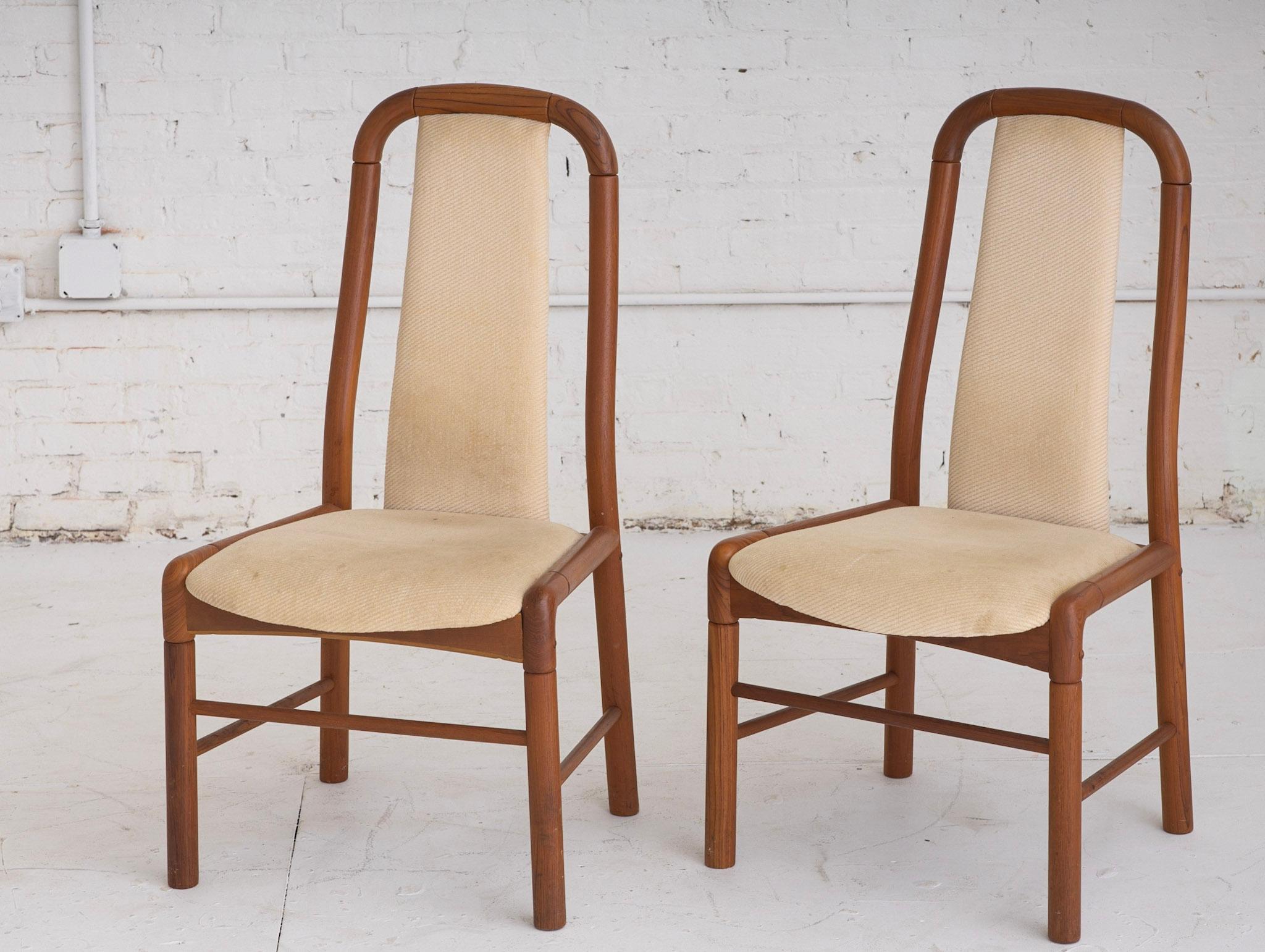 A set of 8 dining chairs from Benny Linden Design. Sculptural teak with original textured cream upholstery.
