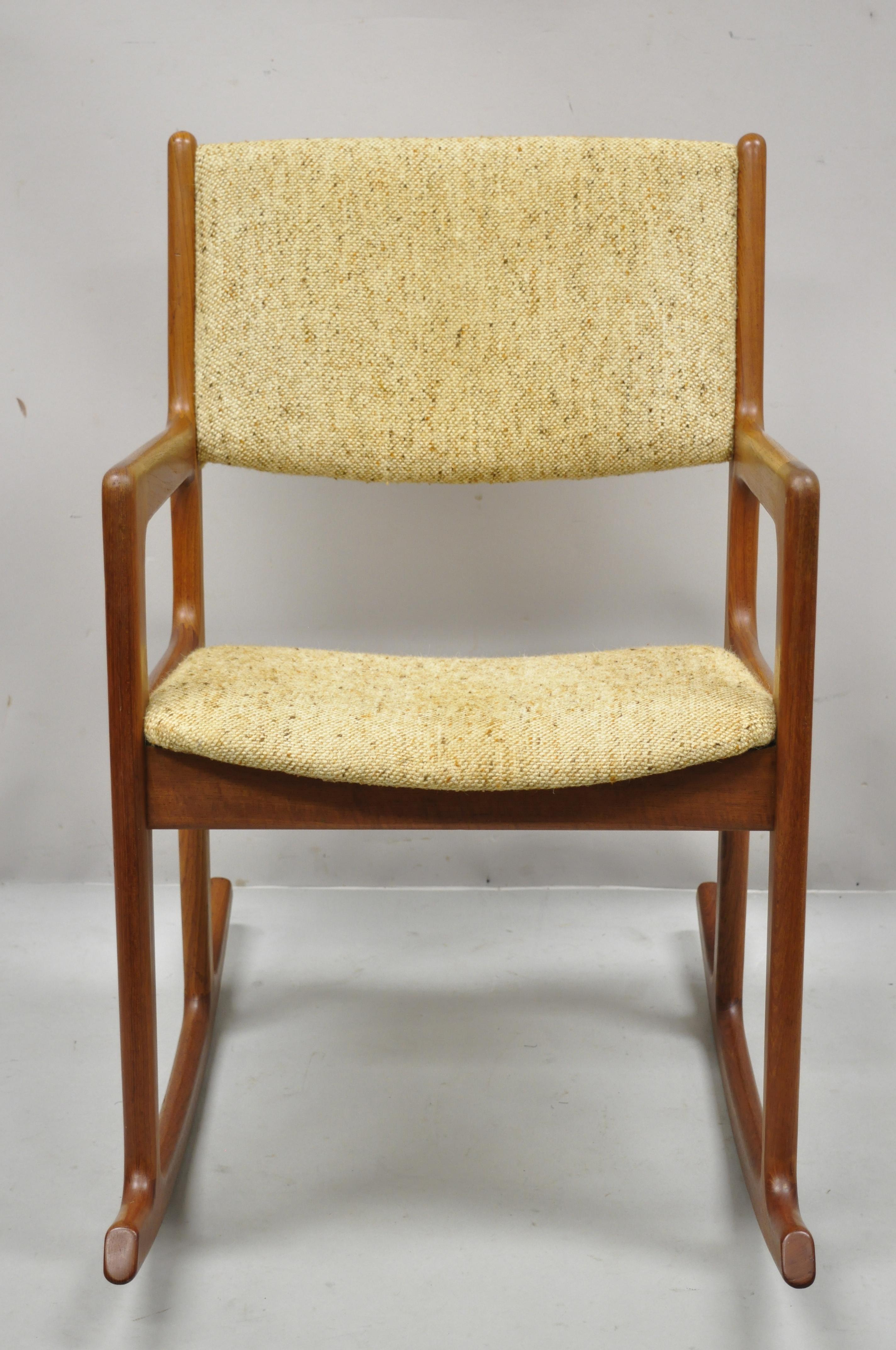 Benny Linden Mid-Century Modern Danish style teak wood rocker rocking chair. Item features solid teak wood frame, beautiful wood grain, original label, clean modernist lines, quality craftsmanship, sleek sculptural form, Circa mid 20th century.