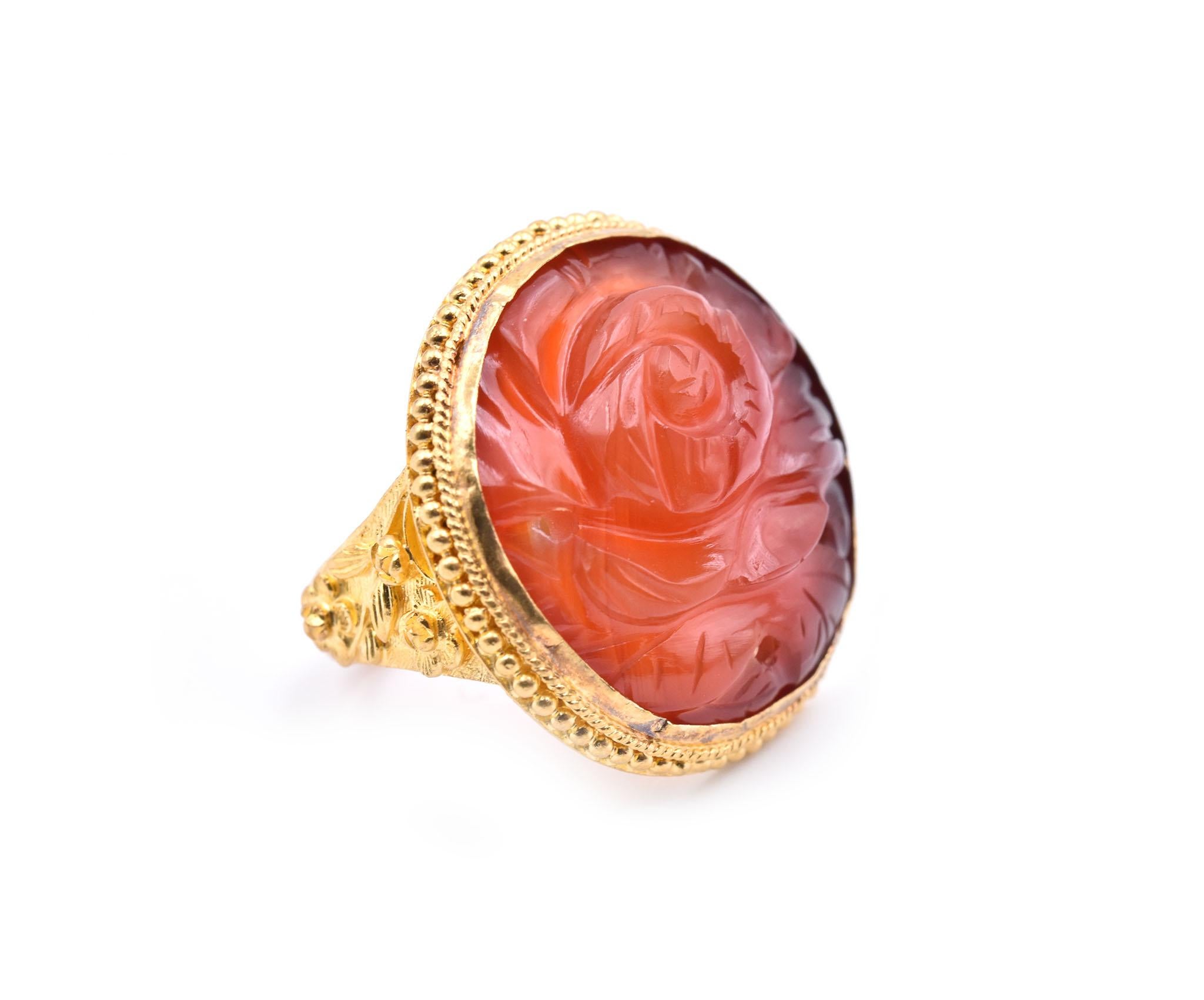 Designer: custom design
Material: 24k yellow gold
Gemstone: Rose Jade
Ring size: 4 (please allow two additional shipping days for sizing requests) 
Dimensions: ring top measures 23.60mm in diameter
Weight: 9.89 grams
