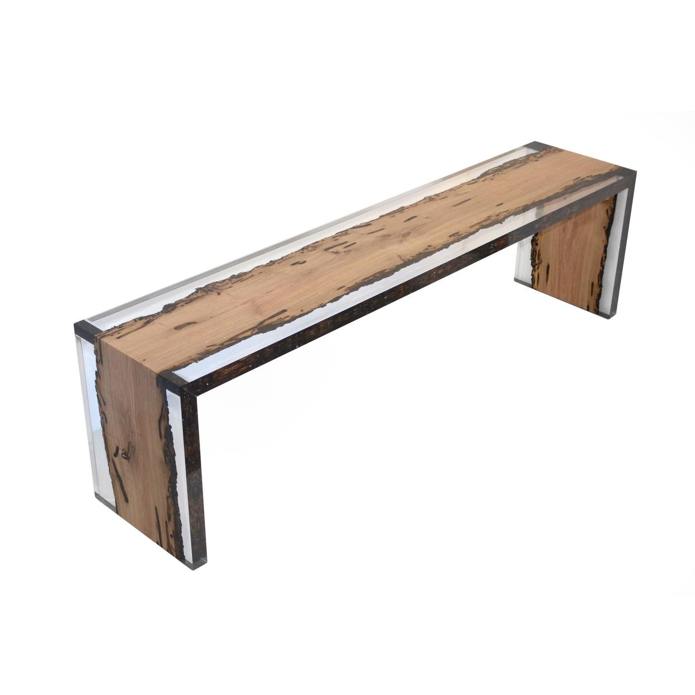 This elegant bench is made using a single plank of oak wood reclaimed from the Venetian laguna cut in three parts. The edges of the plank, aged by salt and water, are preserved in a clear resin that evokes the waters of the canals that have sculpted