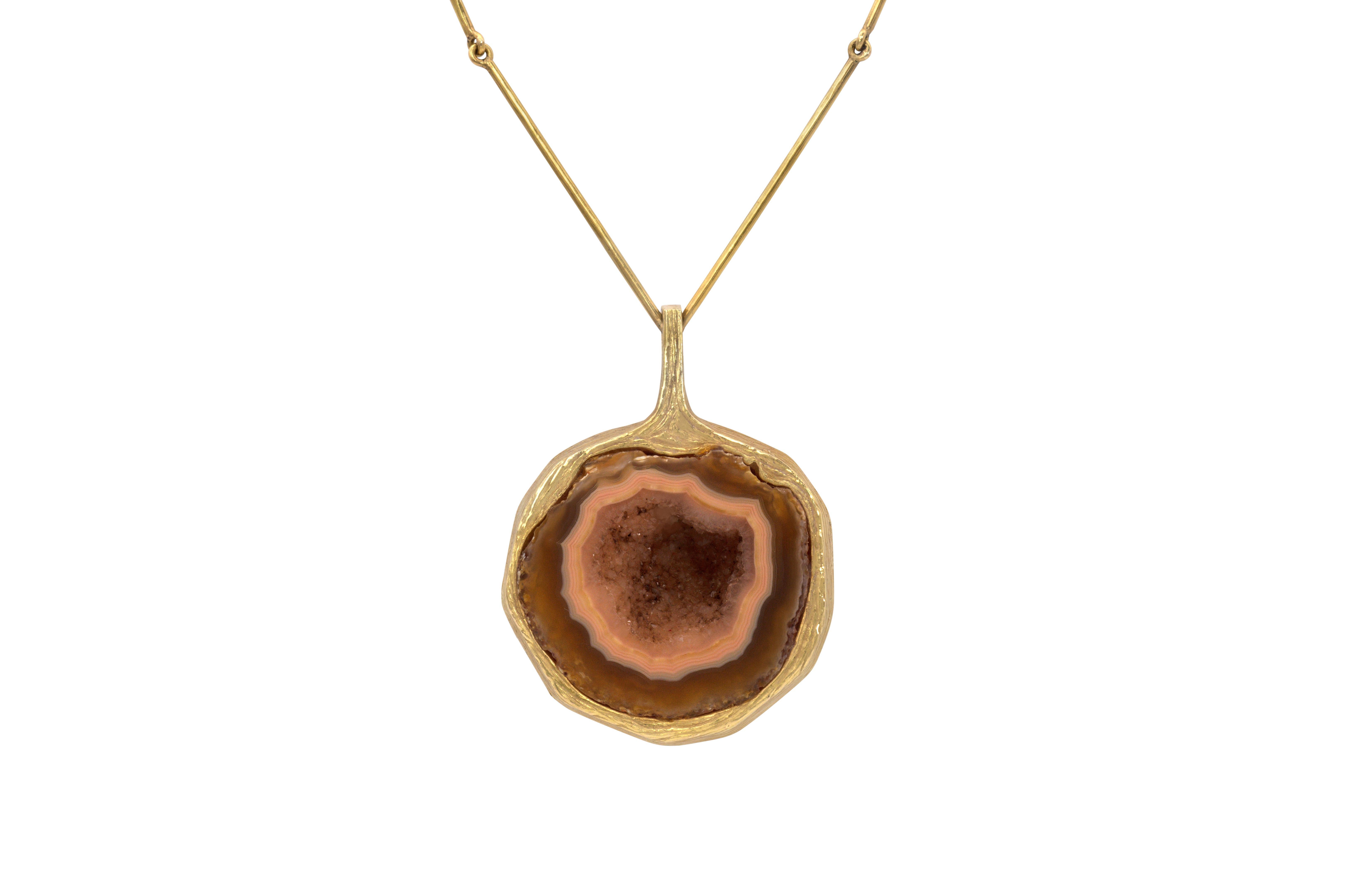 A handmade carved agate and 18-karat gold pendant necklace by Bent Gabrielsen, Denmark circa 1975. Back of pendant stamped: makers mark, B. Gabrielsen P., Denmark, U 193, 750. Toggle stamped: BGP 750 DENMARK.

Gabrielsen most often worked in silver;