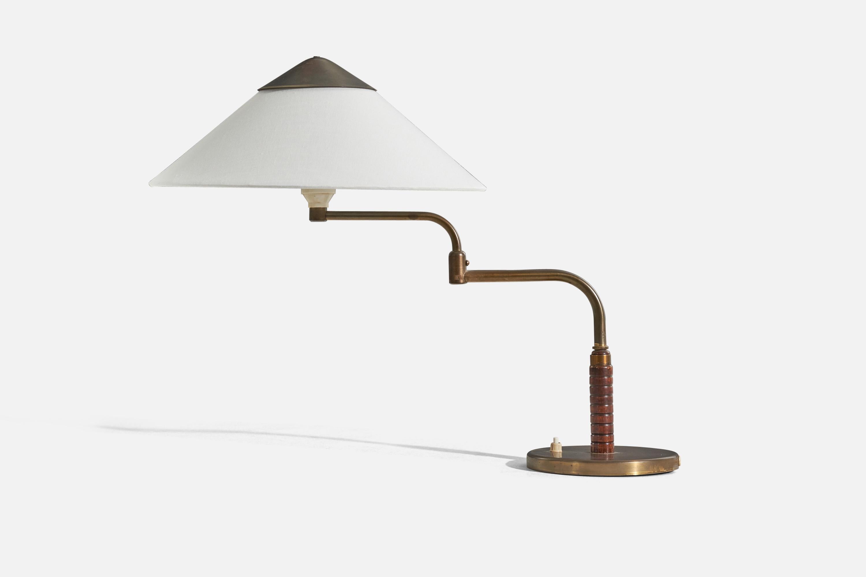 A brass, wood and fabric table lamp designed and produced by Bent Karlby, Denmark, 1940s. 

Sold with Lampshade. 
Stated dimensions refer to the Lamp with the Shade. 
Variable dimensions, measured in the table lamp's minimum extended position.