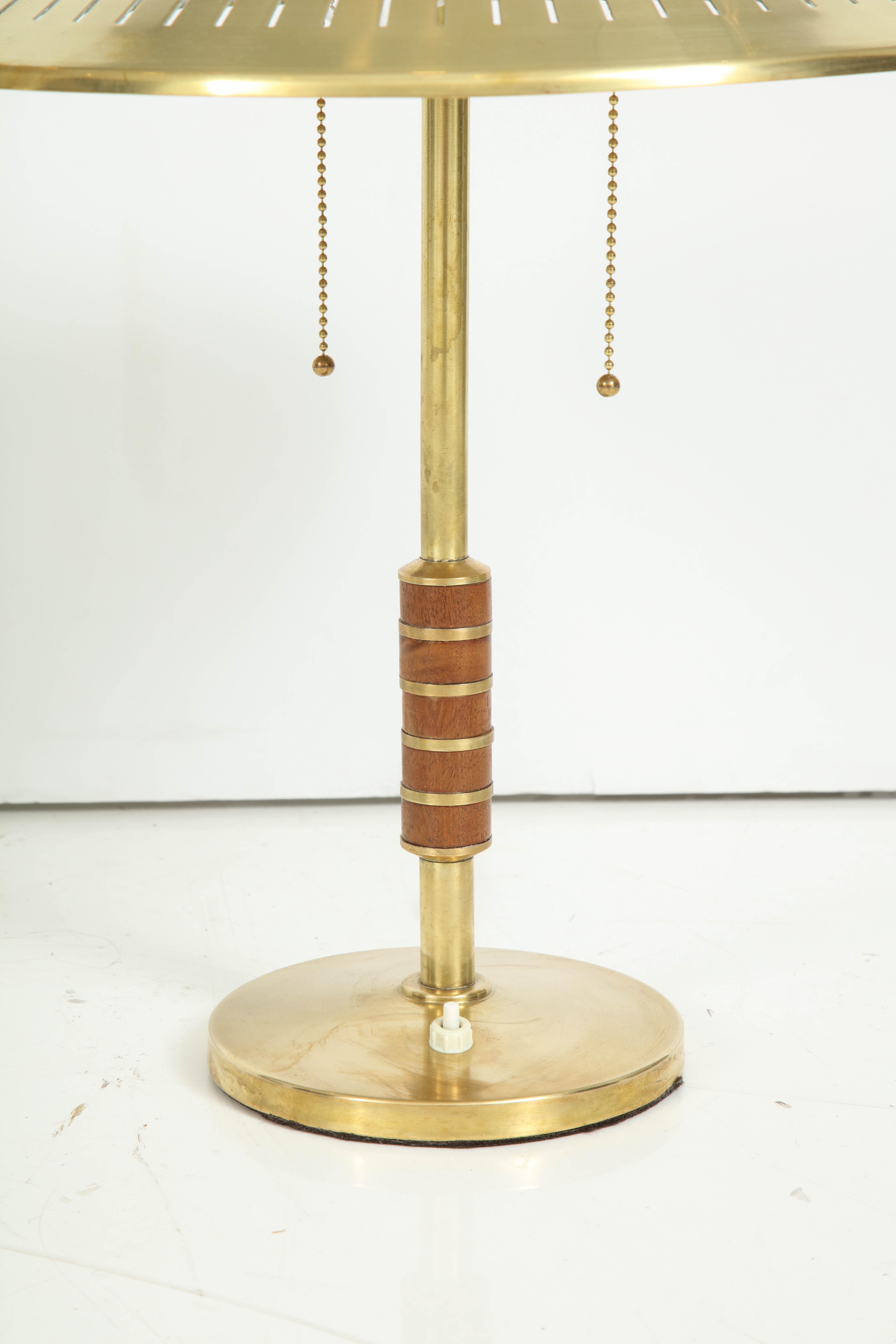A Danish brass table lamp produced by Lyfa 1956 and designed by Bent Karlby. Model B146. Solid brass cone form shade with two-lights , stem with teak banding. Re-wire for the US. Two 60 watt max.