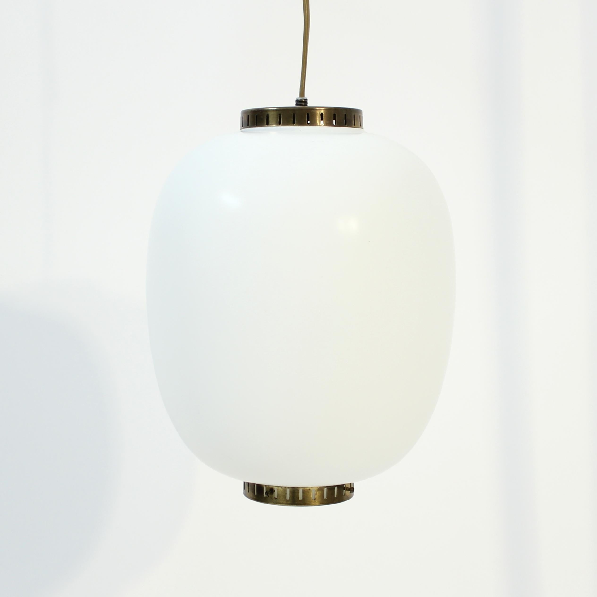Ceiling lamp, model Kina (China in English), designed by Danish designer Bent Karlby for LYFA in the 1960s. Oval shaped opaline glass shade with brass details on the top and bottom. Very good and honest vintage condition with light ware and patina
