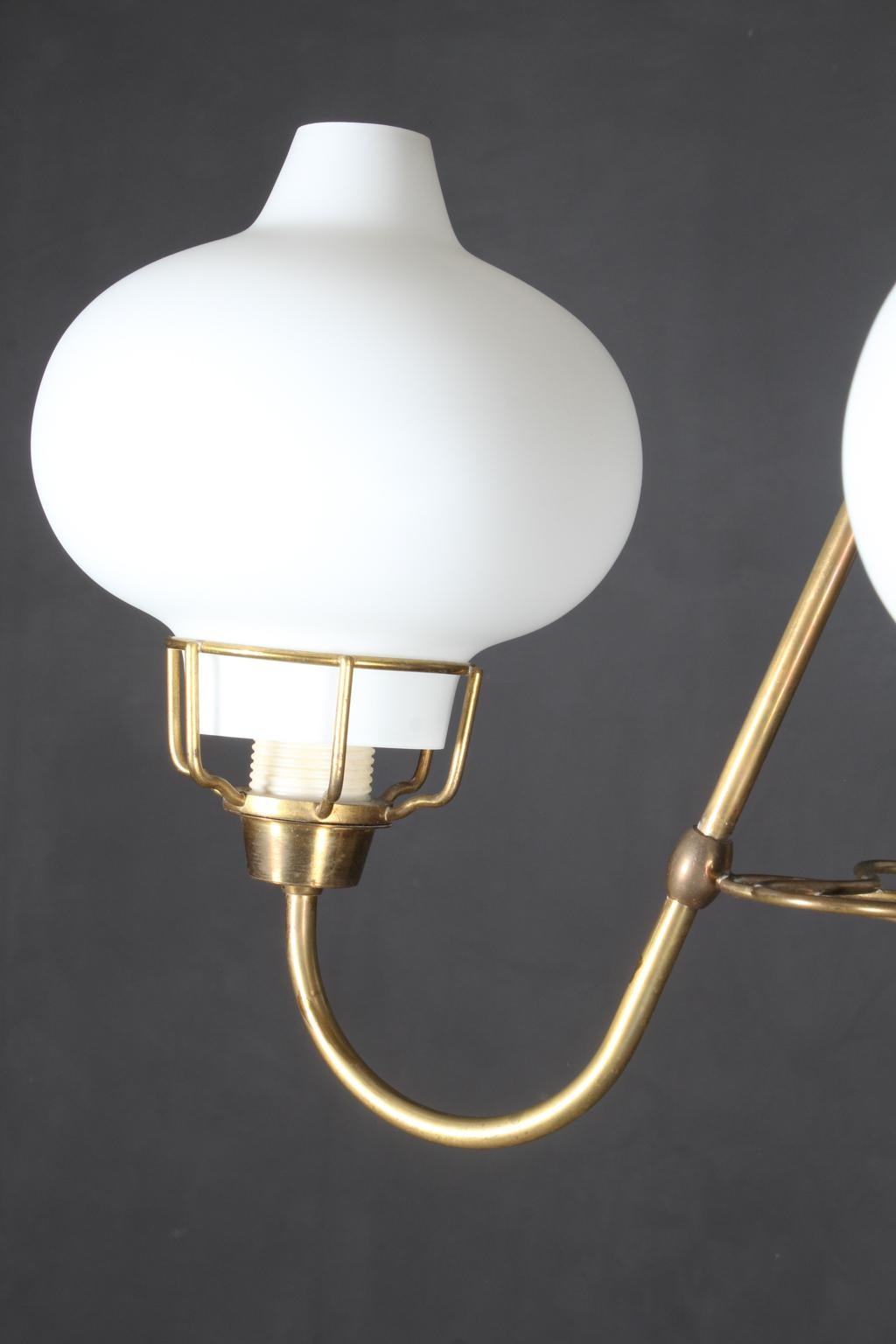 Bent Karlby pendant in opal glass and brass. Three light sources.

Made by Lyfa.