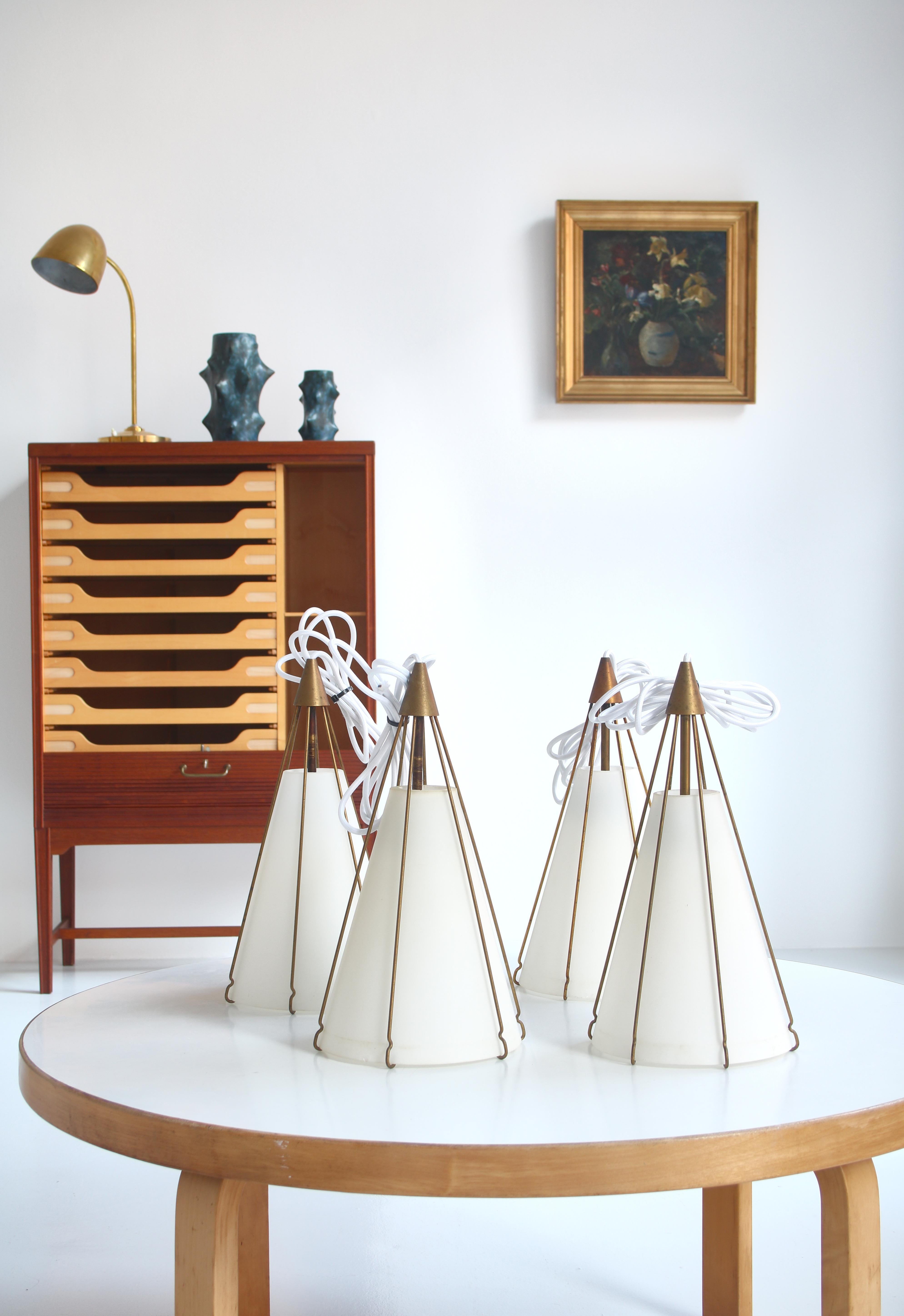 Rare pendant lamp designed by Bent Karlby in the early 1950s for lightning company LYFA, Denmark. Cone shaped opaline shades and brass mounts. Good original condition.