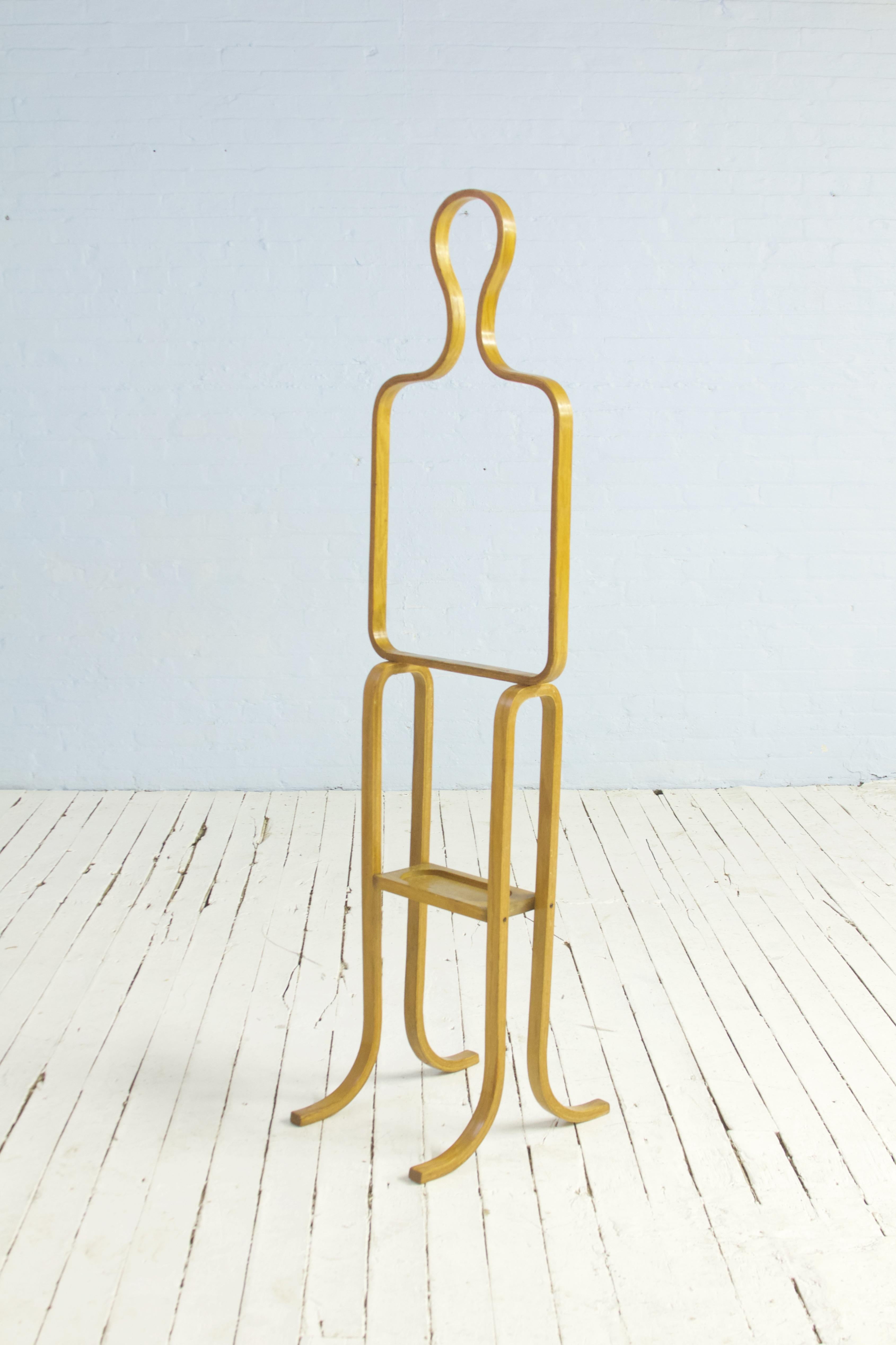 Playful bent-laminated beech valet in the shape of a standing figure, United States circa 1950. This piece can support a hat as well as jackets and features a solid beech 