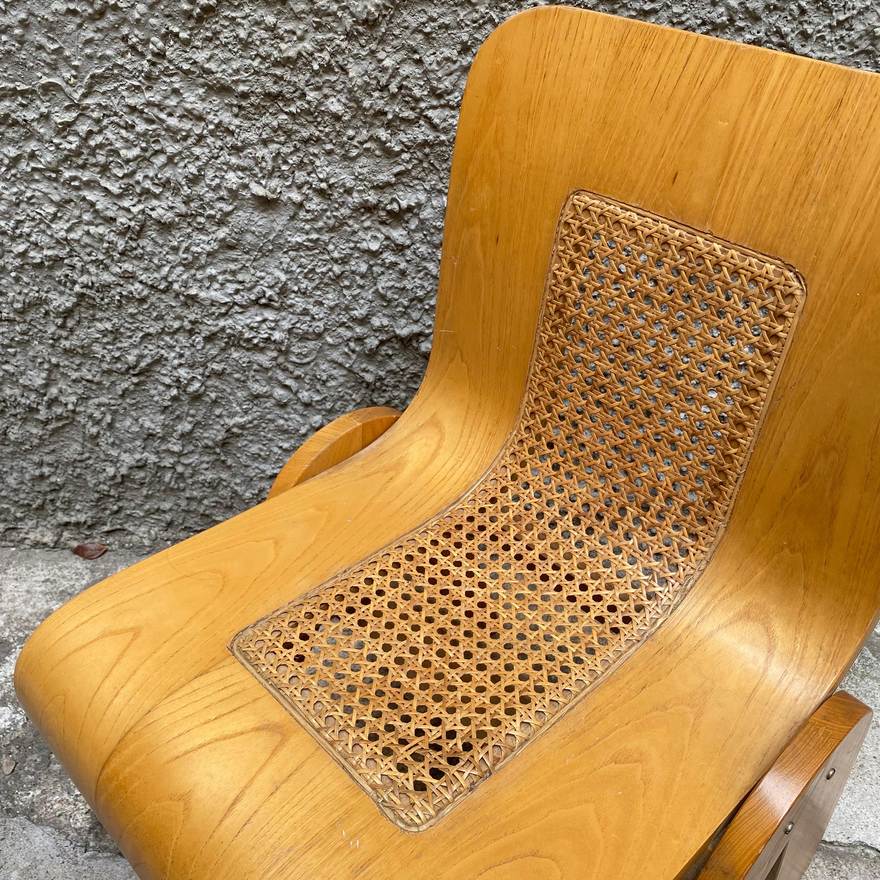 An inventive design by the Italian Gigi Sabadin, this chair is made of bent plywood with a veneered finish. The organic design seems to be made of one piece, which is cut and bent. The backrest features an open space adding extra lightness to the