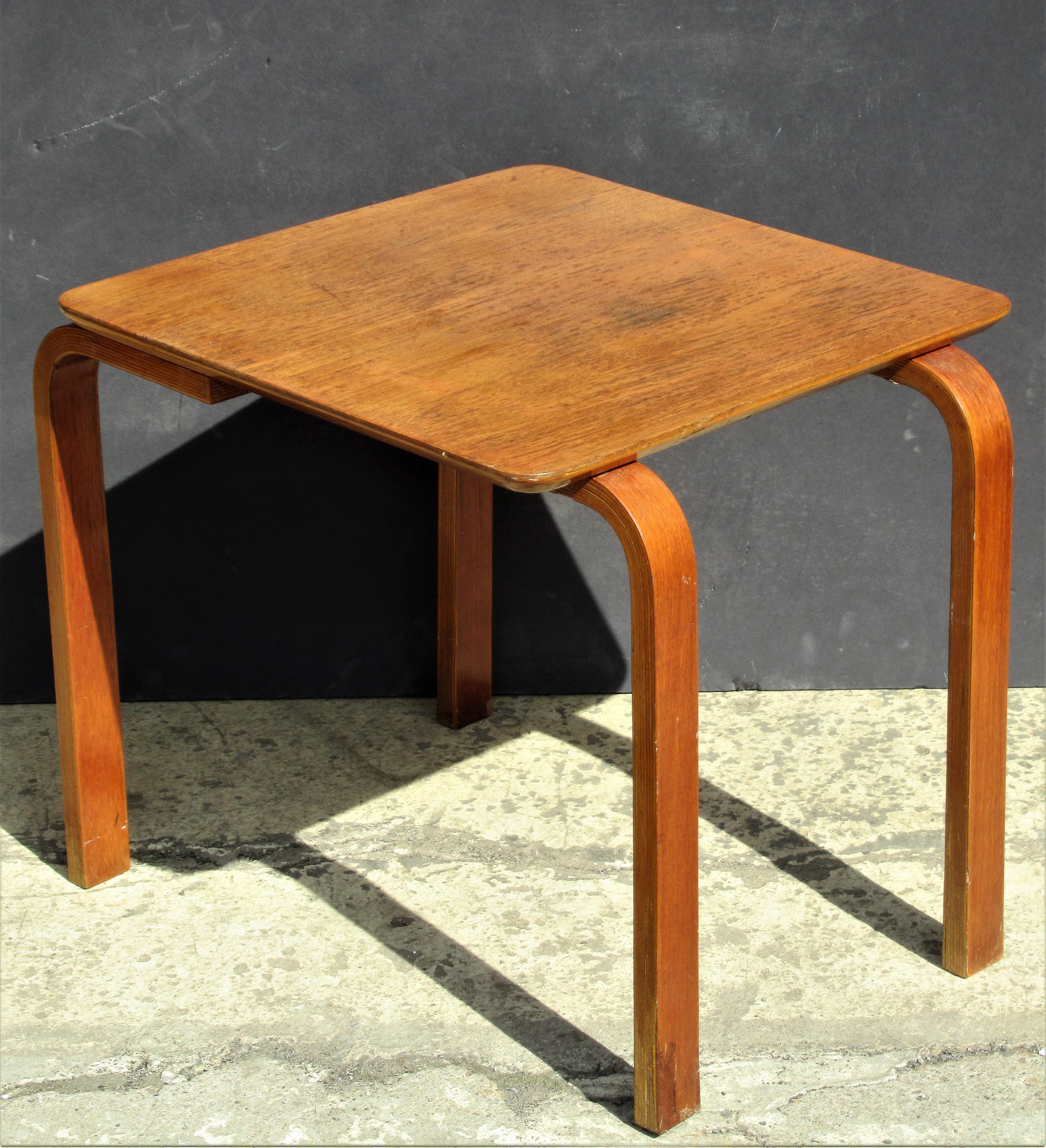 ln the style of early Alvar Aalto for Finmar an unusual bent stack laminated plywood and teak veneer occasional side table in all original aged condition with no restorations. Stamped branded on underside in by all legs and center - Made in Denmark.