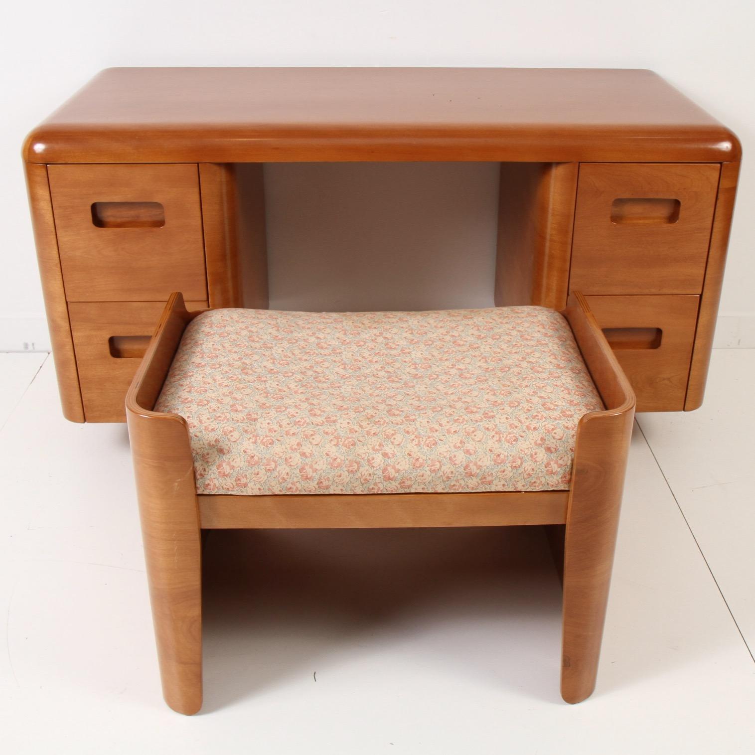 Here is a great example of pre-war cool design and technology; bent plywood furniture. This is a rather hard to find petite vanity and rare matching seat. Seat is an easy recover as shown. Both pieces have been painstakingly restored and ready for