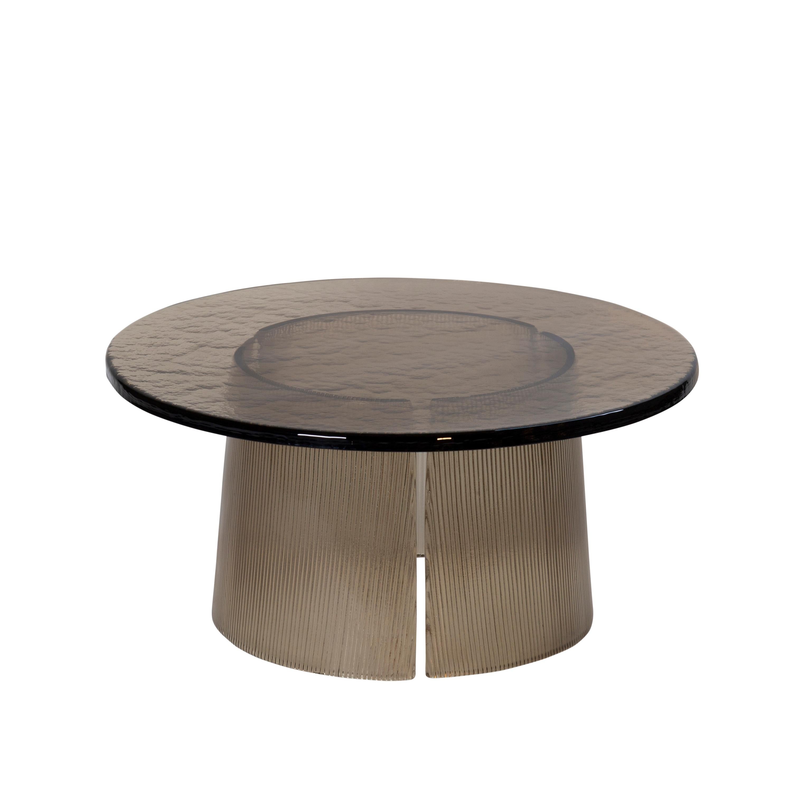 Bent side table big smoky grey by Pulpo
Dimensions: D 75 x H 35 cm
Materials: casted glass

Also available in different finishes and dimensions.

The bubbled surface of the cast glass table top dances against with the smooth lines of the