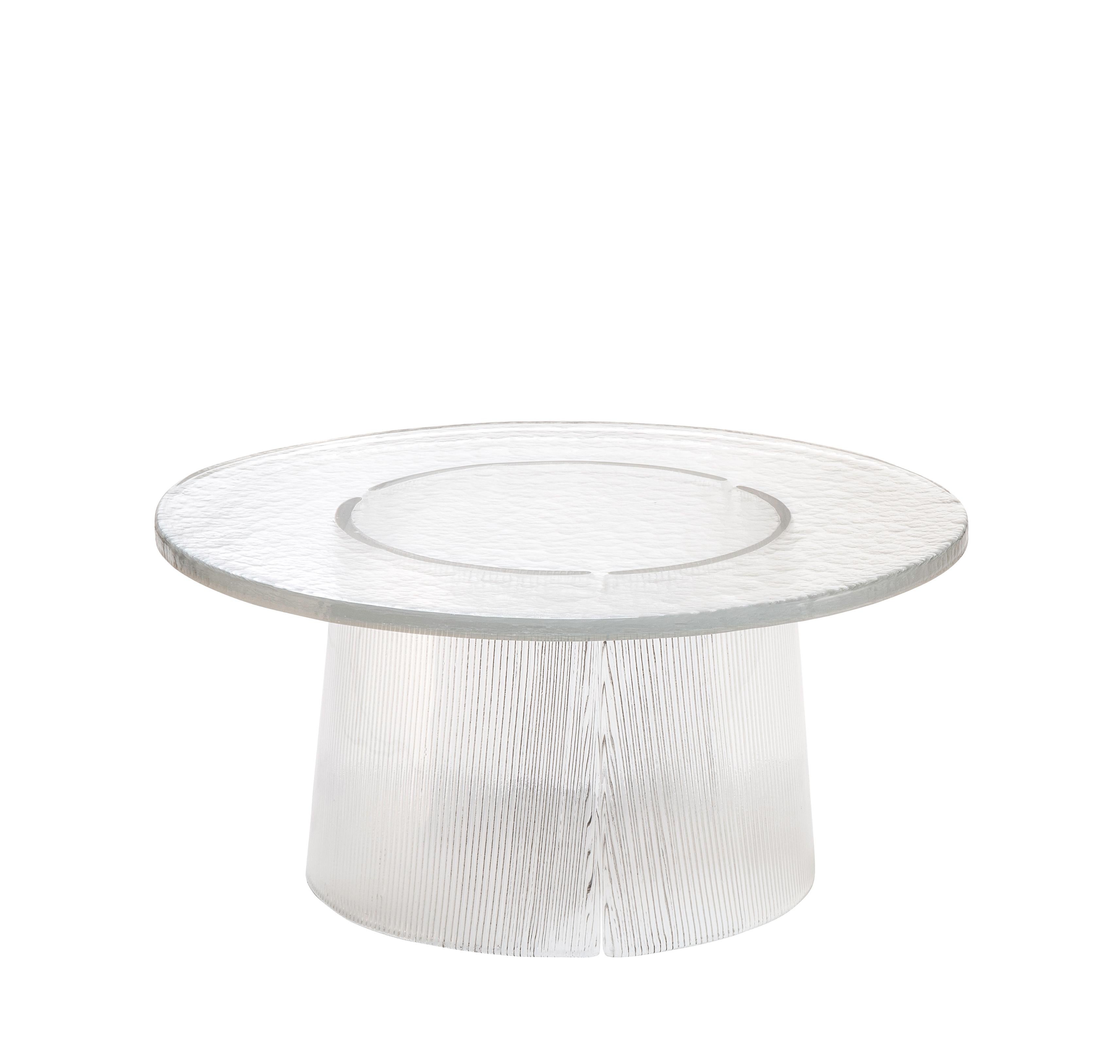 Bent side table big transparent by Pulpo.
Dimensions: D75 x H35 cm.
Materials: casted glass.

Also available in different finishes and dimensions. 

The bubbled surface of the cast glass table top dances against with the smooth lines of the