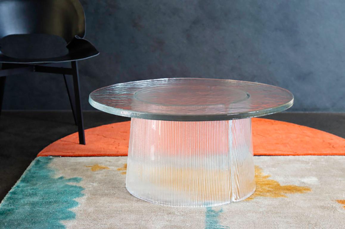 Bent side table, European, Minimalist, transparent, German, table, big size, transparent.

The bubbled surface of the cast glass tabletop dances against the smooth lines of the fluted cast glass base. The bent side table expresses the beauty of
