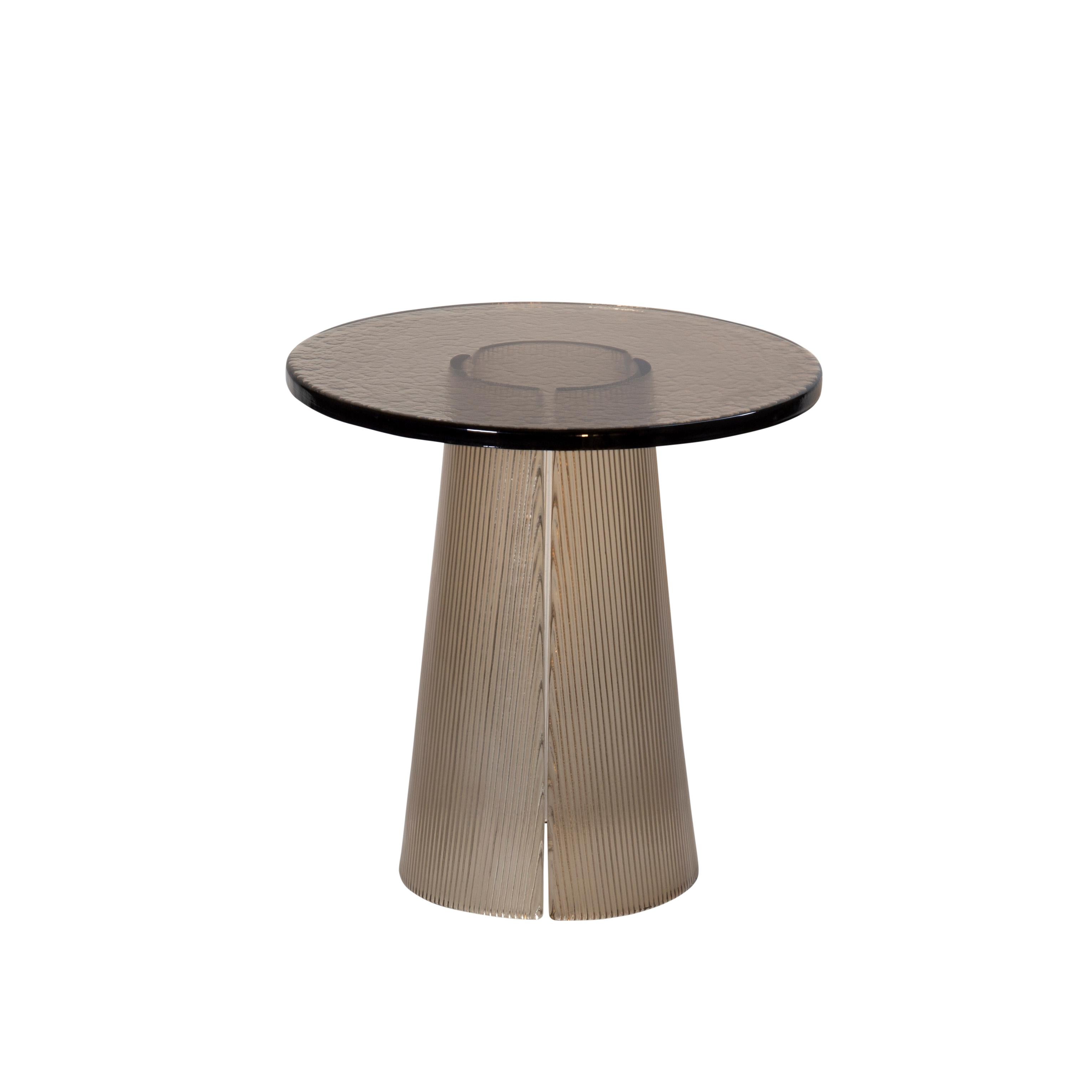 Bent side table high smoky grey by Pulpo
Dimensions: D50 x H51.5 cm.
Materials: casted glass.

Also available in different finishes and dimensions. 

The bubbled surface of the cast glass table top dances against with the smooth lines of the