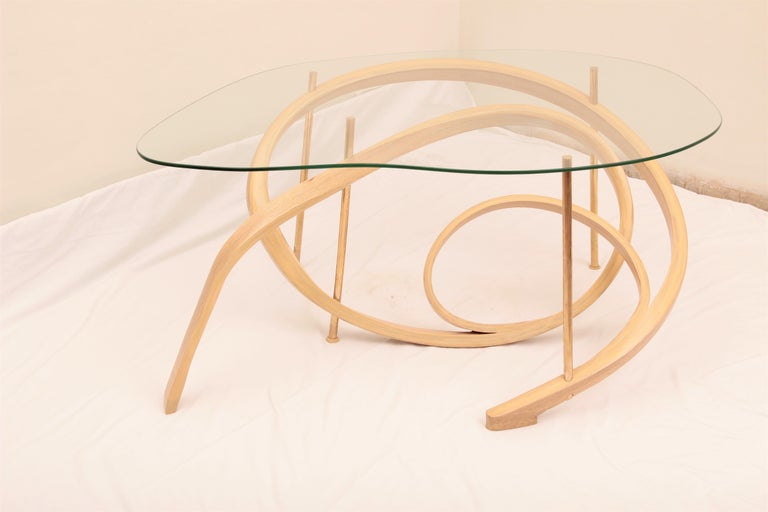 A coffee table made with bent ashwood, finished in clear lacquer and brass rods holding the intricate design in place. The Studio has designed the table to mimic the swirls of a vine; creating a different design perspective from each angle.

Our