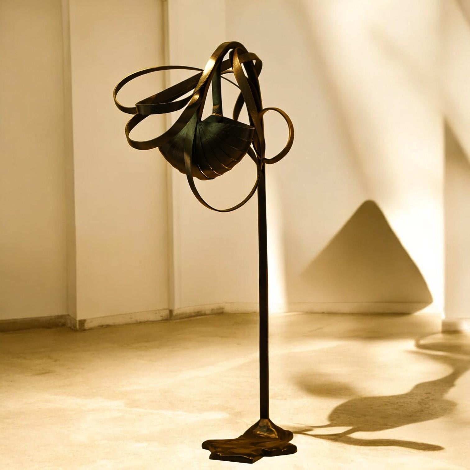 This arc lamp stands over 6 ft tall and has been finished in coal black to have a strong presence that complements its size. Abstract bent wood design surrounds the solid wood lamp-shade to create a canopy like structure. 

Our Vrksa Collection is