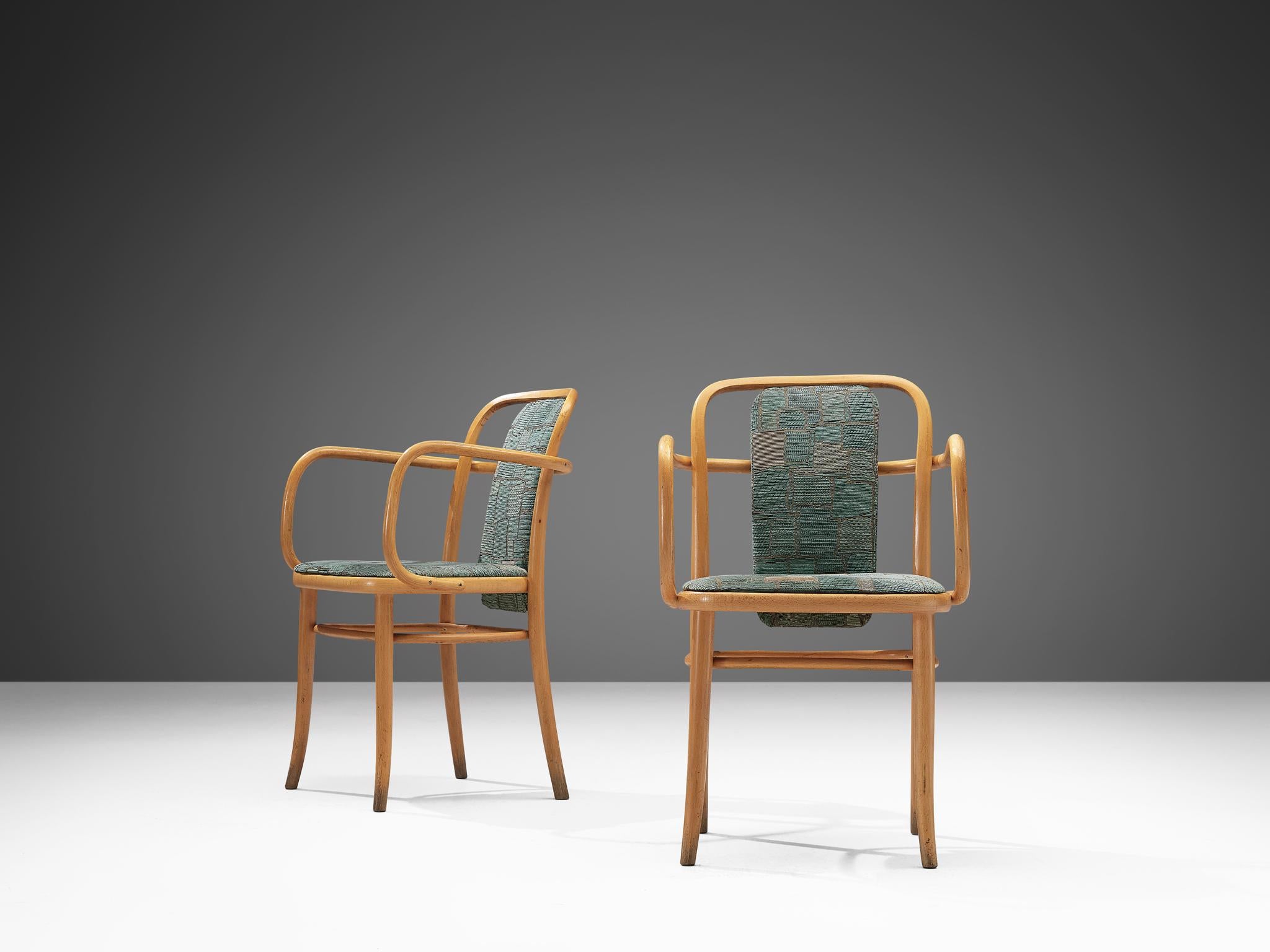 Dining chairs, bentwood and textured aquamarine upholstery, Europe, 1960s.
 
Pair of elegant armchairs in bentwood. The bentwood armrests have sinuous lines, flowing across the open backrests. With the upholstered backrest and seating the chairs