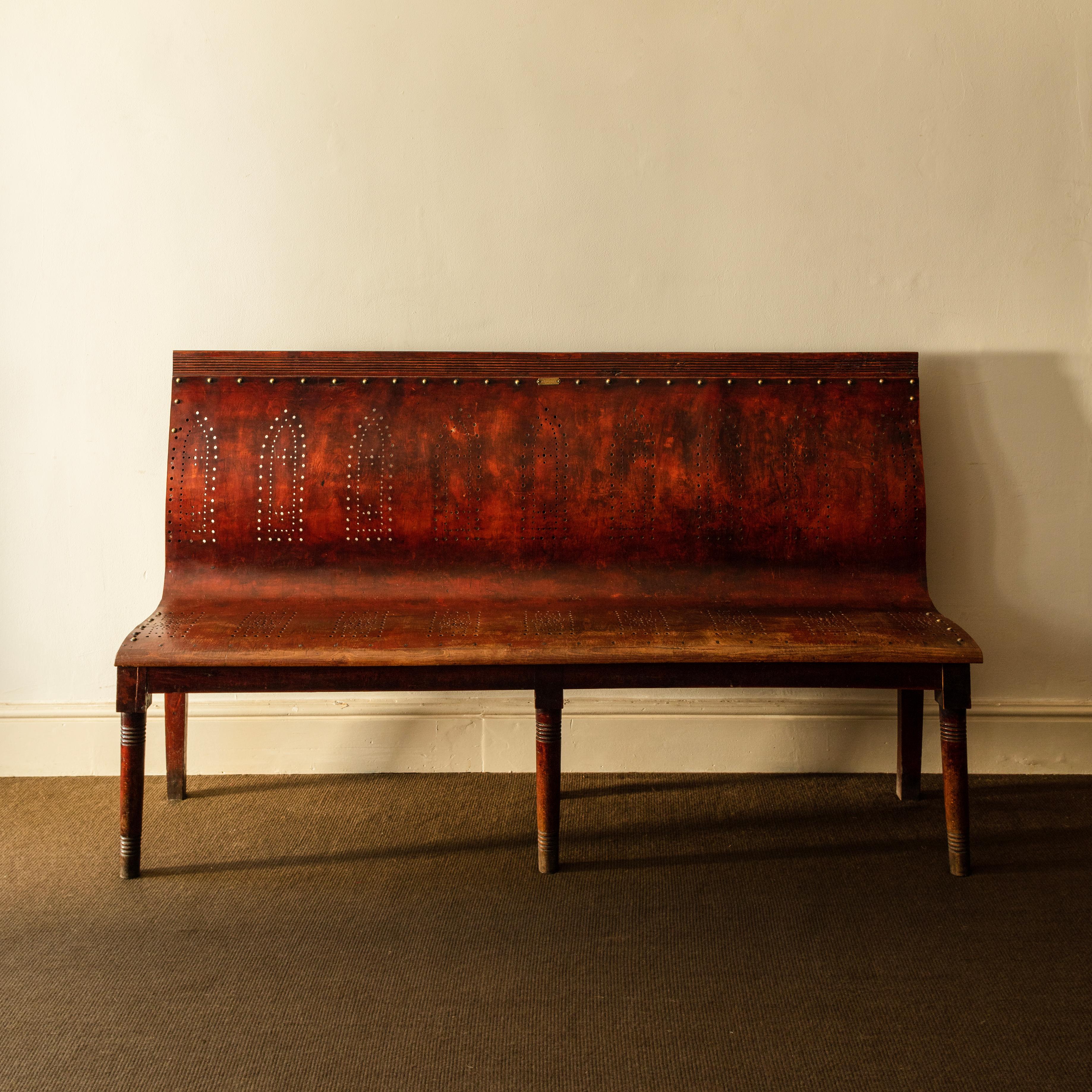 Substantial and comfortable bentwood bench, the seat with a pattern of pierced boxes, the back with a series of gothic arches.

With a small makers label for Cambier Freres, a well respected manufacturer of bentwood utility furniture. Lille,