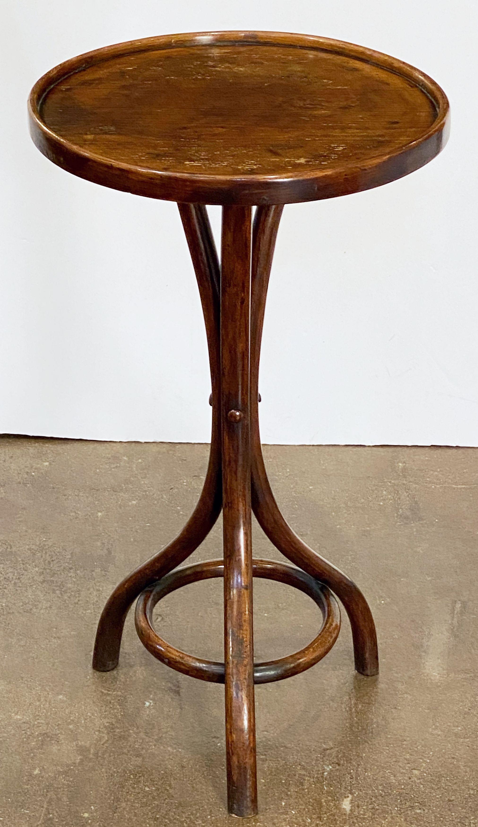 A fine French bentwood cafe or bistro table featuring a round or circular moulded top over a stylish bentwood tripod frame.