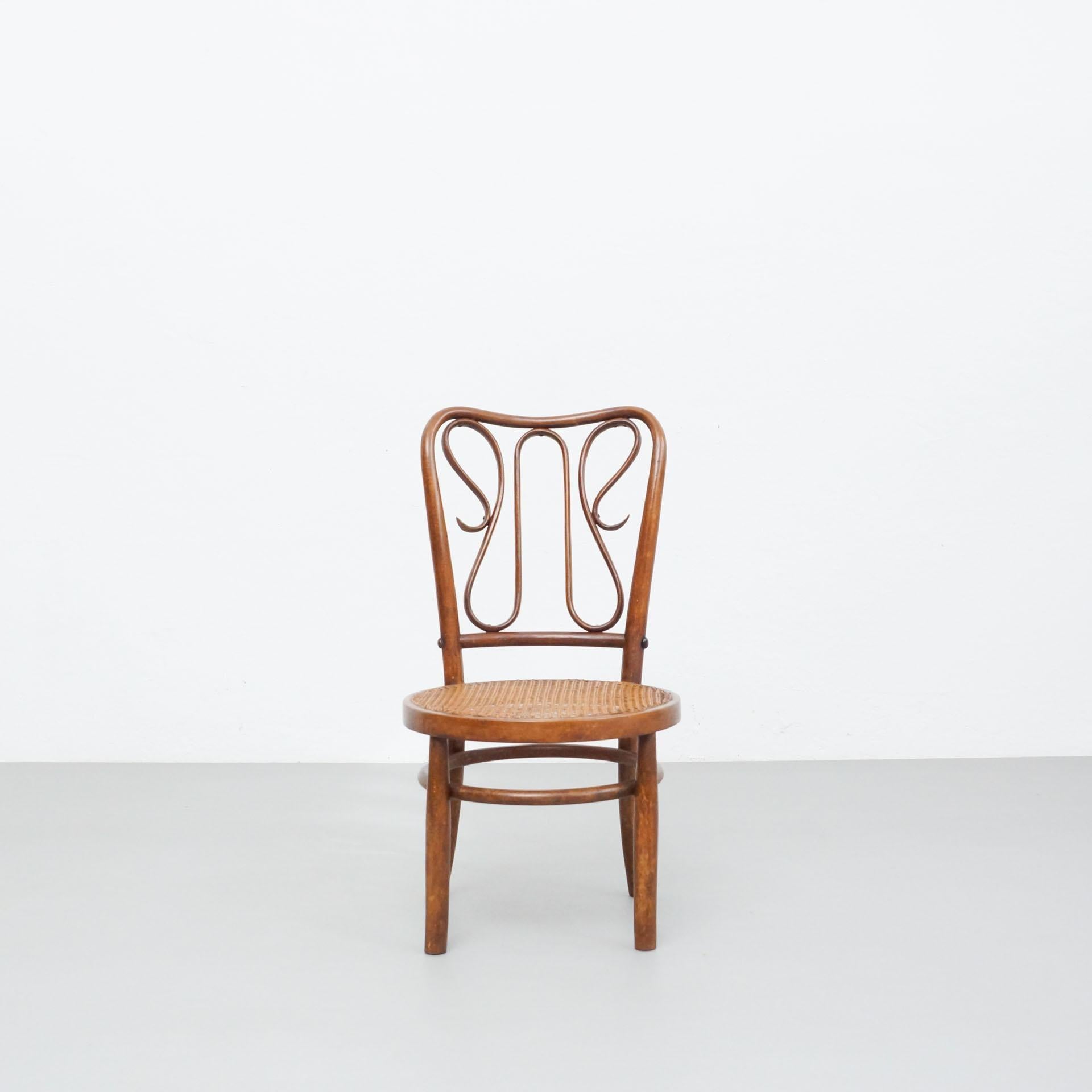 Bentwood chair by unknown designer and manufacturer in the style of Thonet.  Made in France, circa 1940.    In original condition with minor wear consistent with age and use, preserving a beautiful patina.    Materials:  Wood  Rattan    Dimensions: 