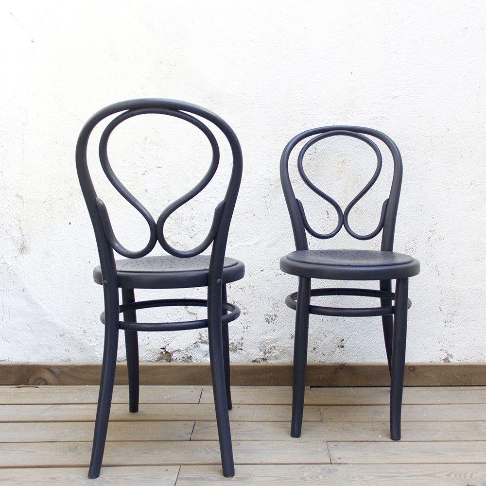 A set of two bentwood chairs made in the 1940s. The beechwood frame has been restored and renovated in a black-coal color. These vintage chairs have an open back and an openwork seat with holes in the shape of a star. 

The chairs are 83 cm tall,