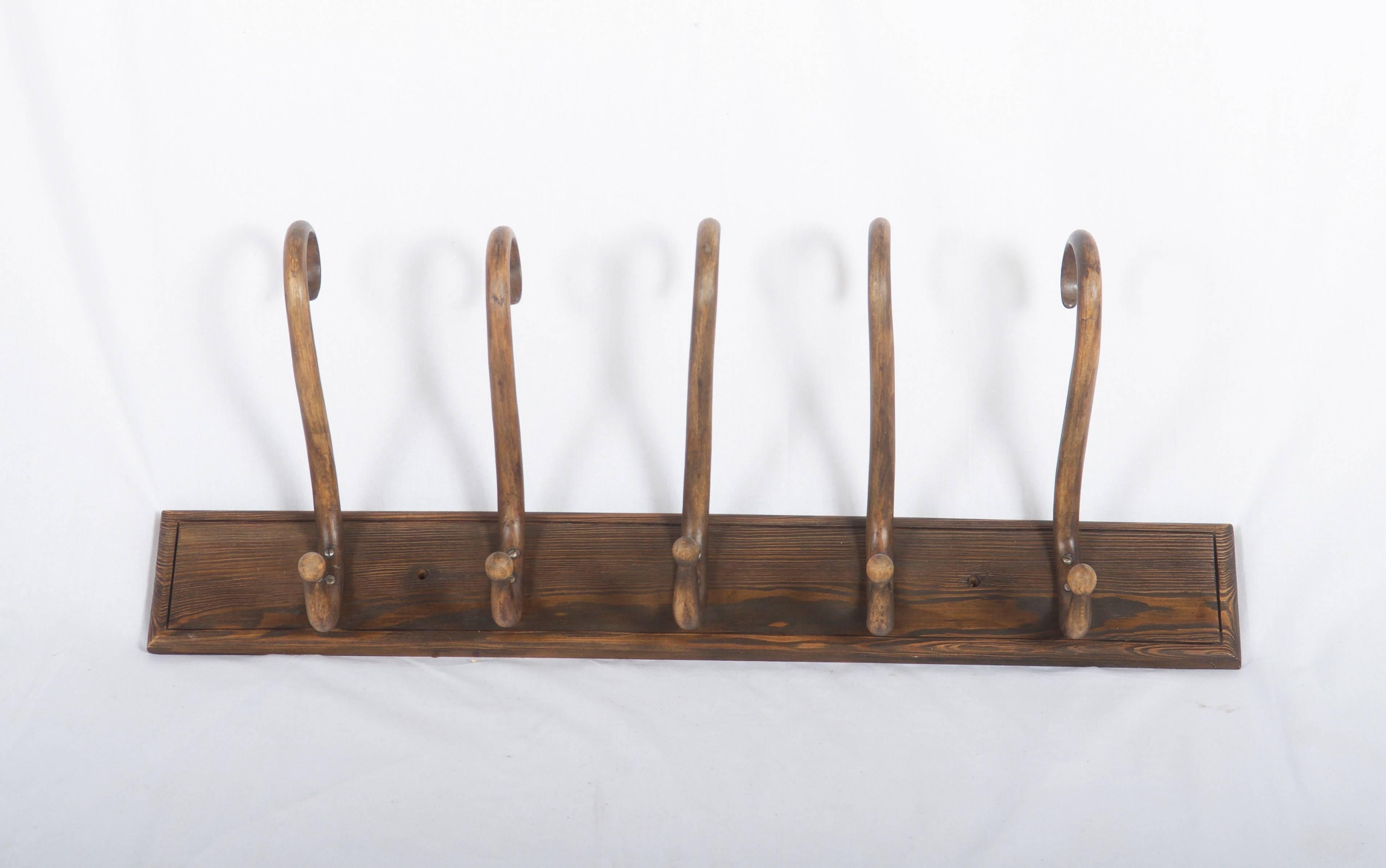Austrian bentwood coat hanger with five S scroll coat or hat hangers mounted on a backplate. Made in the style of Thonet or Kohn.