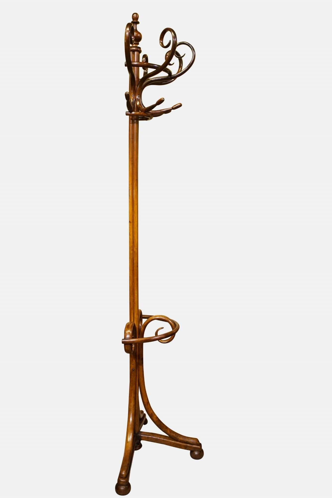 A fine and unusual bentwood coat stand of rare demilune design, excellent condition and color. Totally practical for a narrow hallway.

circa 1880.
     