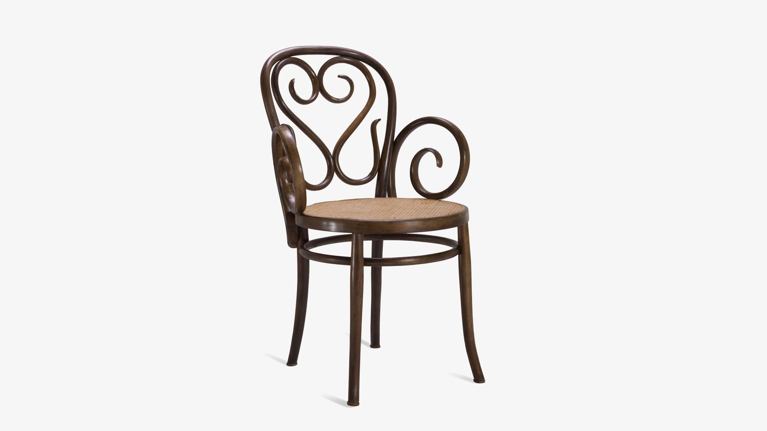 An exquisite example of fine Italian craftsmanship very much in the style of Thonet. These chairs feature intricate woodwork that is wonderfully visually seductive. Generous swooping arms are the staple of this particular design which frame a round