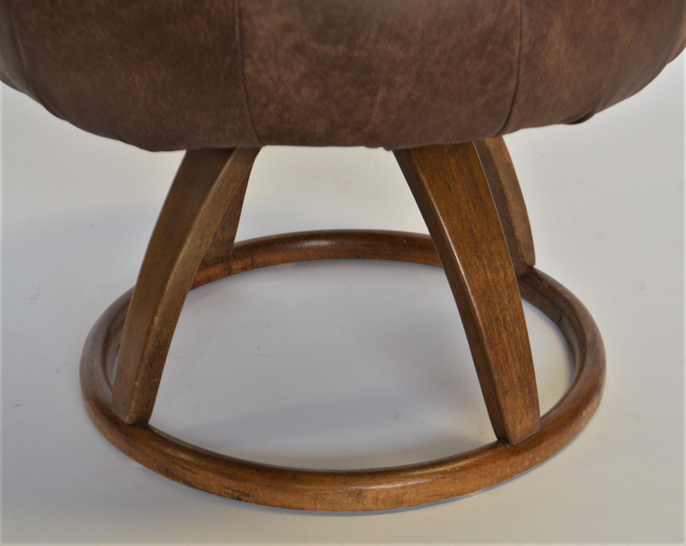 The base of this stool/ bench is a Bentwood production made around 1929- 1930.
The base has the swivel mechanism. The upholstery has been newly done using a distressed style new leather.