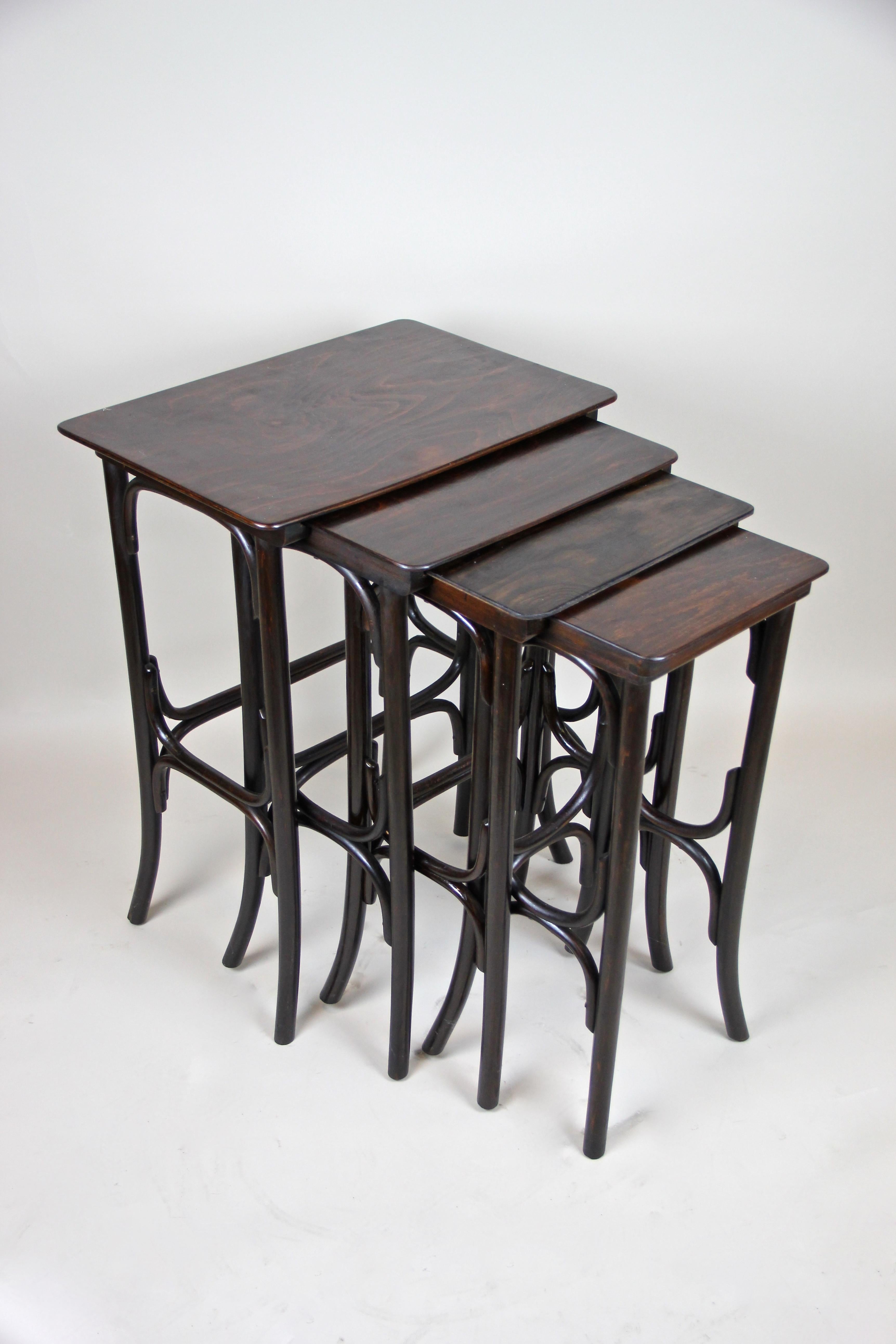 Lovely set of four bentwood nesting tables from the Art Nouveau period circa 1905 made by the world famous manufacture of Thonet. The Mod. No. 10 was beautifully made of bent beechwood and trimmed to a very dark mahogany tone. This great Thonet