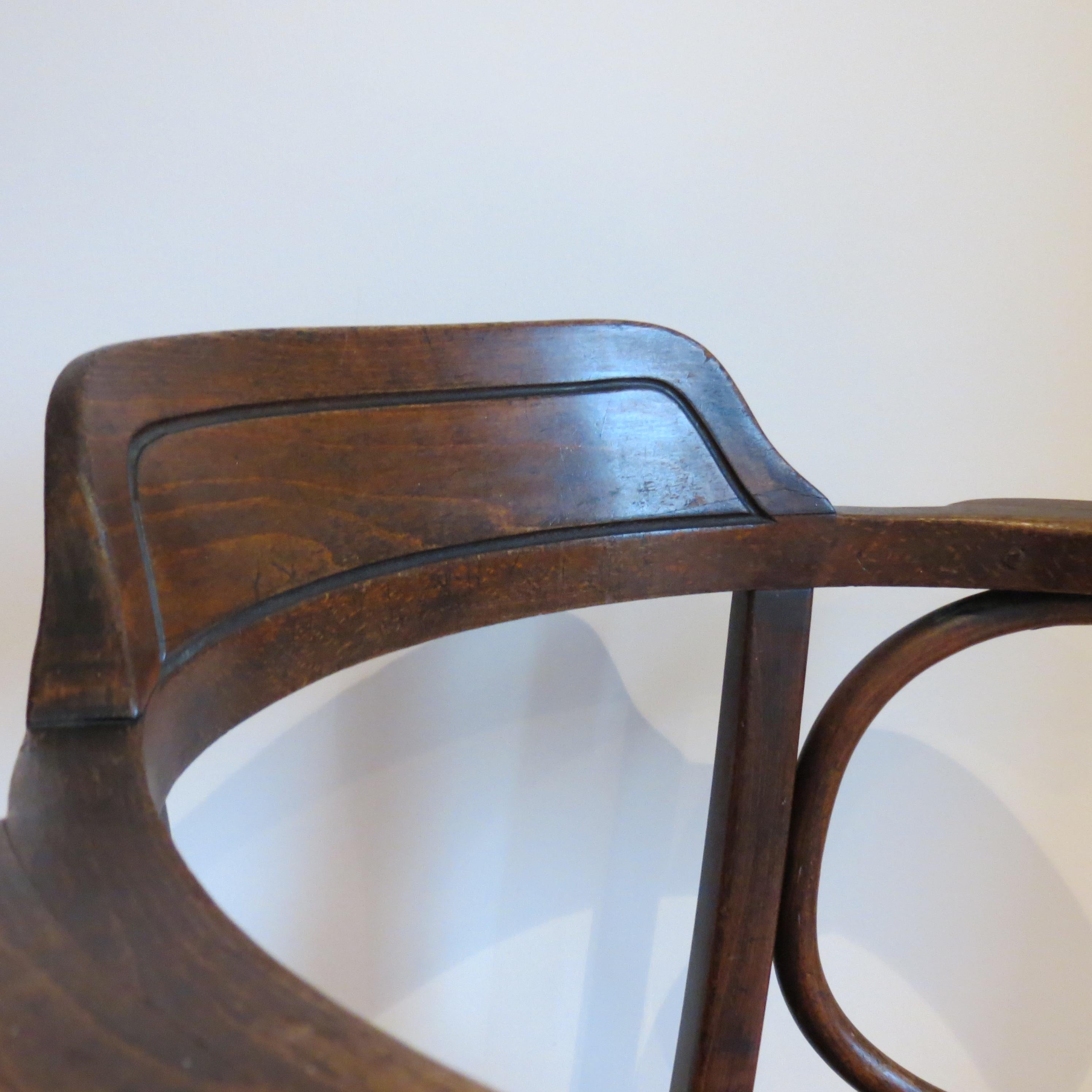 Wonderful bentwood chair, designed by Jacob and Joseph Kohn, Austria and produced by Thonet, dates from the early 1900s.  Model Number 704
Retains the original embossed seat with wonderful shell design.  
Oak back and arms, steamed bentwood