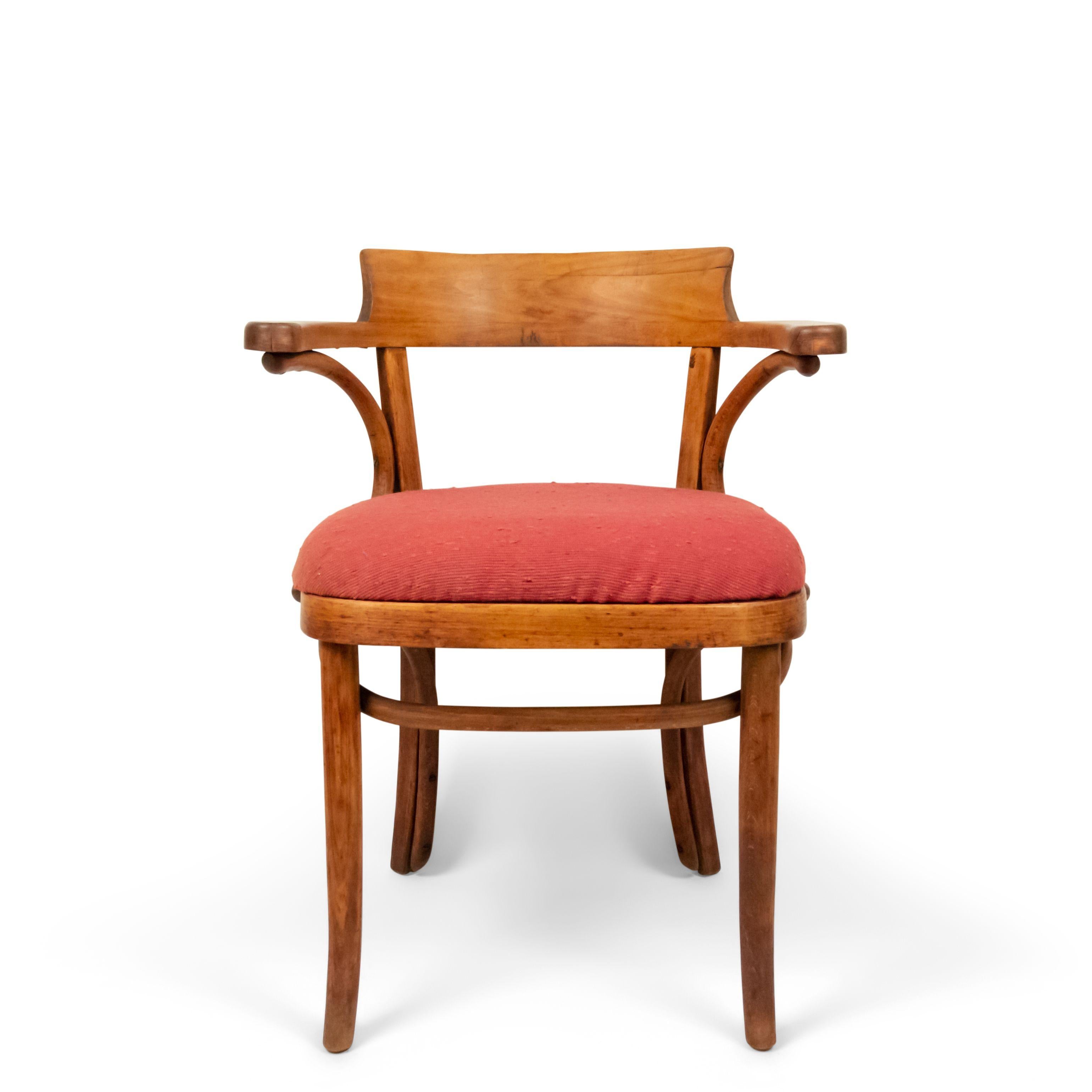 4 bentwood (First quarter of the 20th century) stripped pine and poplar wood round back captains chairs with red seat with label, made in Poland. (Priced each).