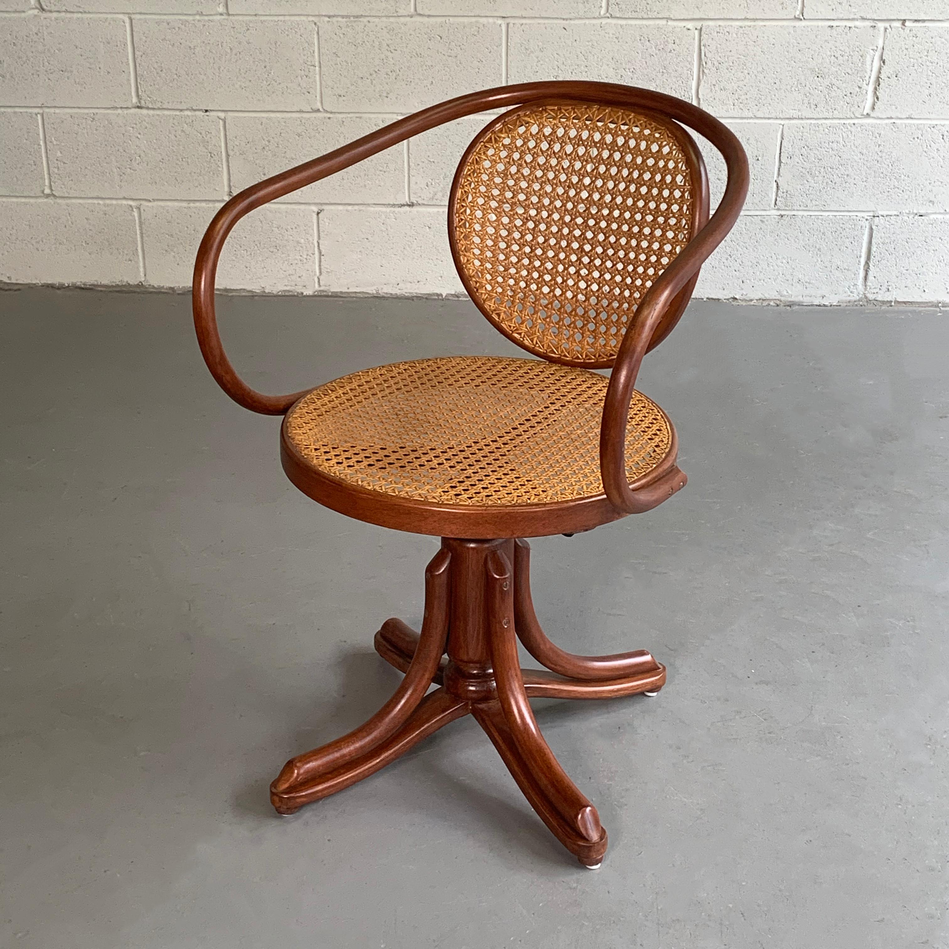 Antique, sculptural, bentwood, swivel armchair by Thonet for ZPM Radomsko features it's original, woven rattan back and seat that is height adjustable from 18 - 22 inches.