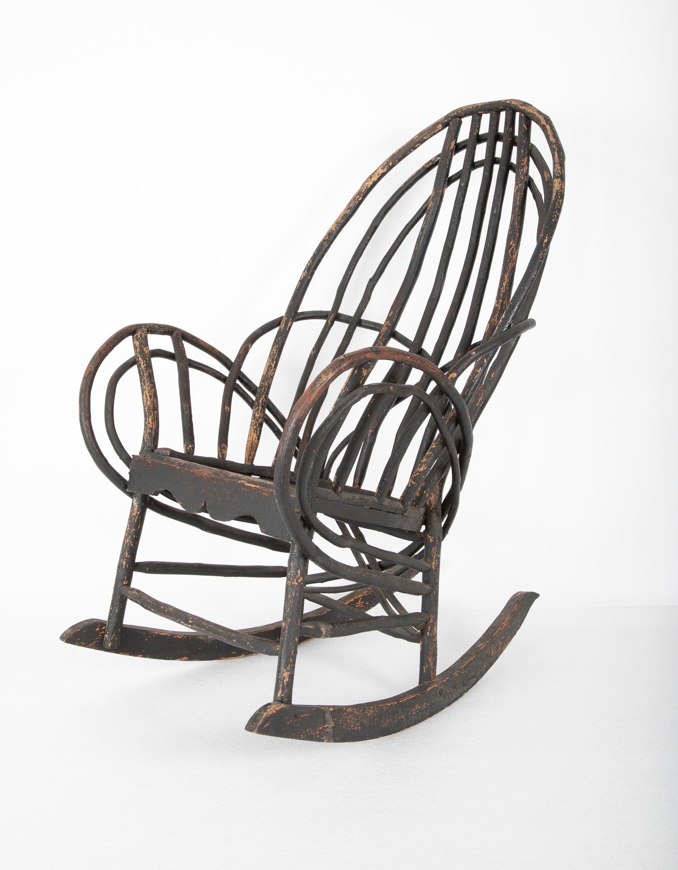 Bentwood rustic armchair-rocker with plank seat & traces of early black paint, American, early 20th century.

 