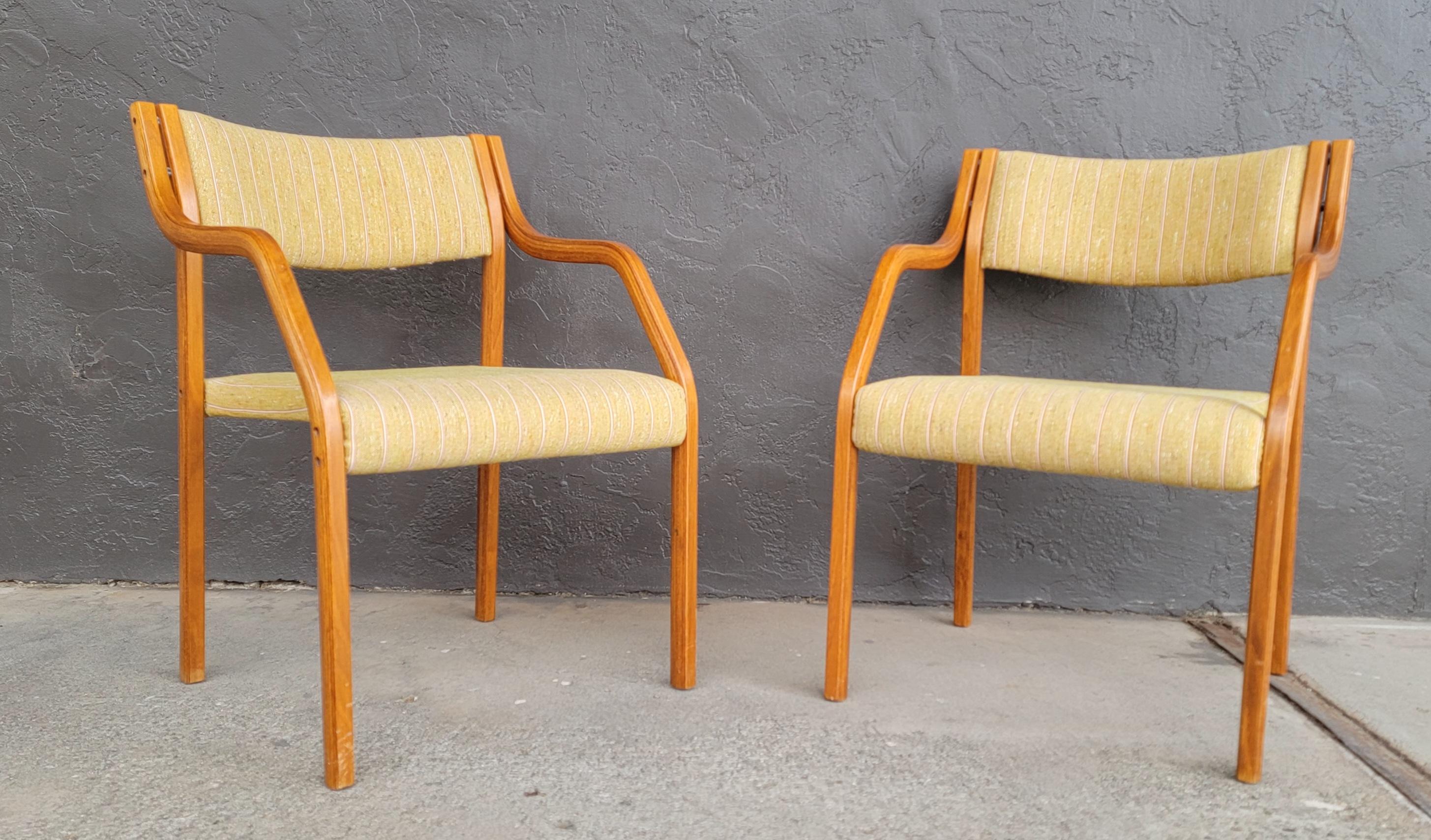Unusual pair of upholstered bentwood armchairs resembling the works of Peter Hvidt, but I have been unable to identify a maker or designer. Steamed laminated bentwood with original upholstery in excellent original condition.