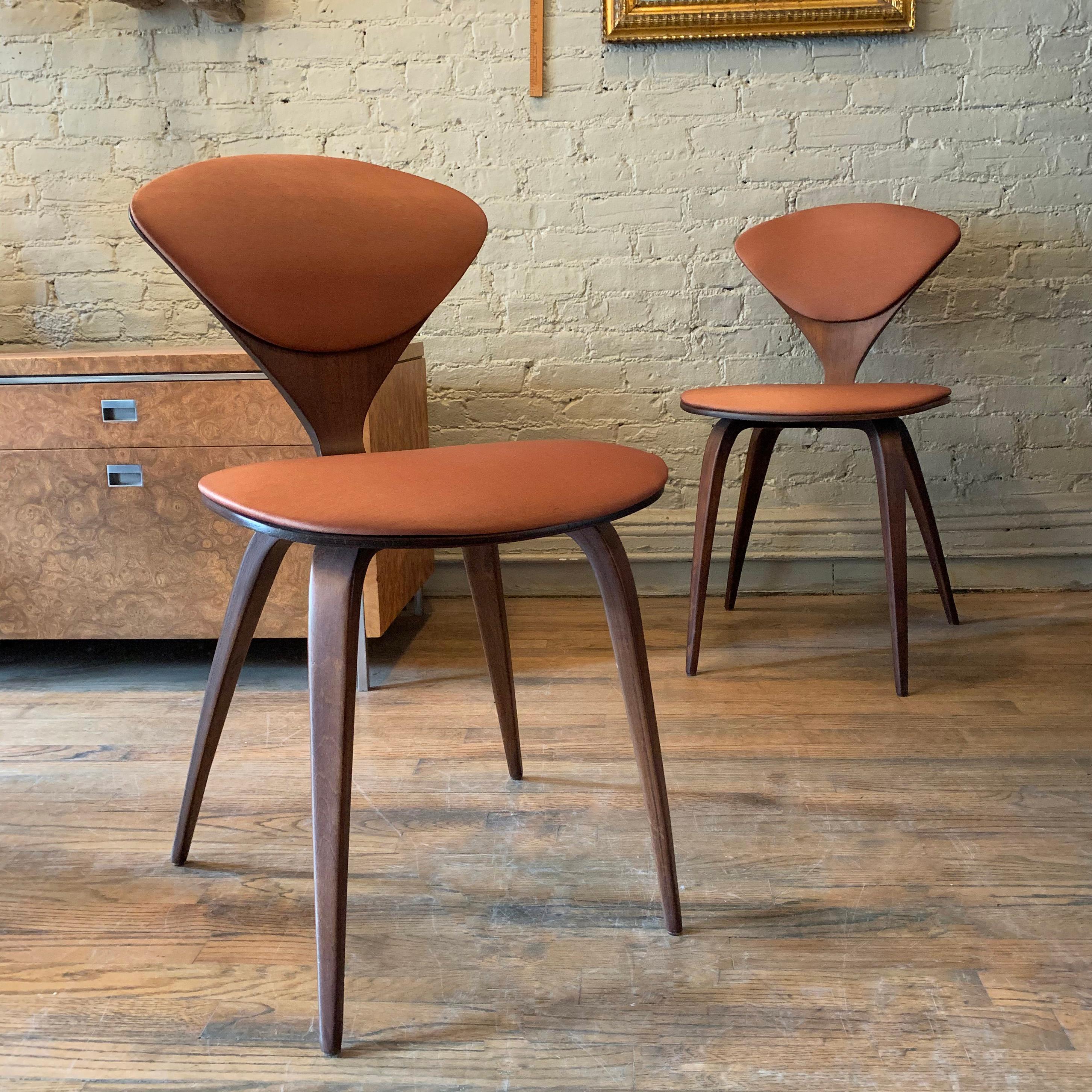 Pair of iconic, maple bentwood chairs by Norman Cherner for Plycraft feature burnt orange sheen upholstery on seat and back.