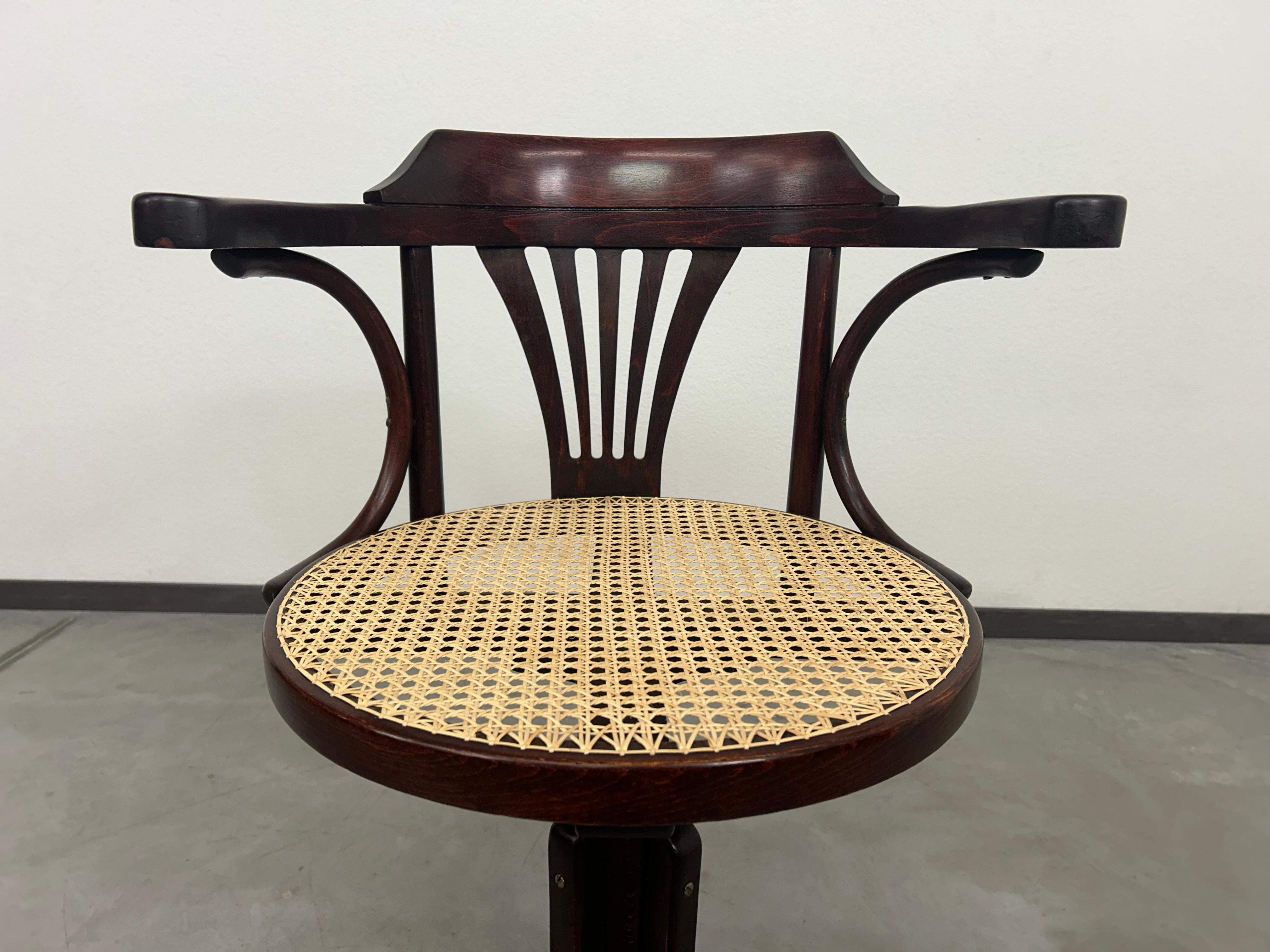 Bentwood swivel office chair by Thonet. Professionally stained and repolished with new hand-made rattan seat.