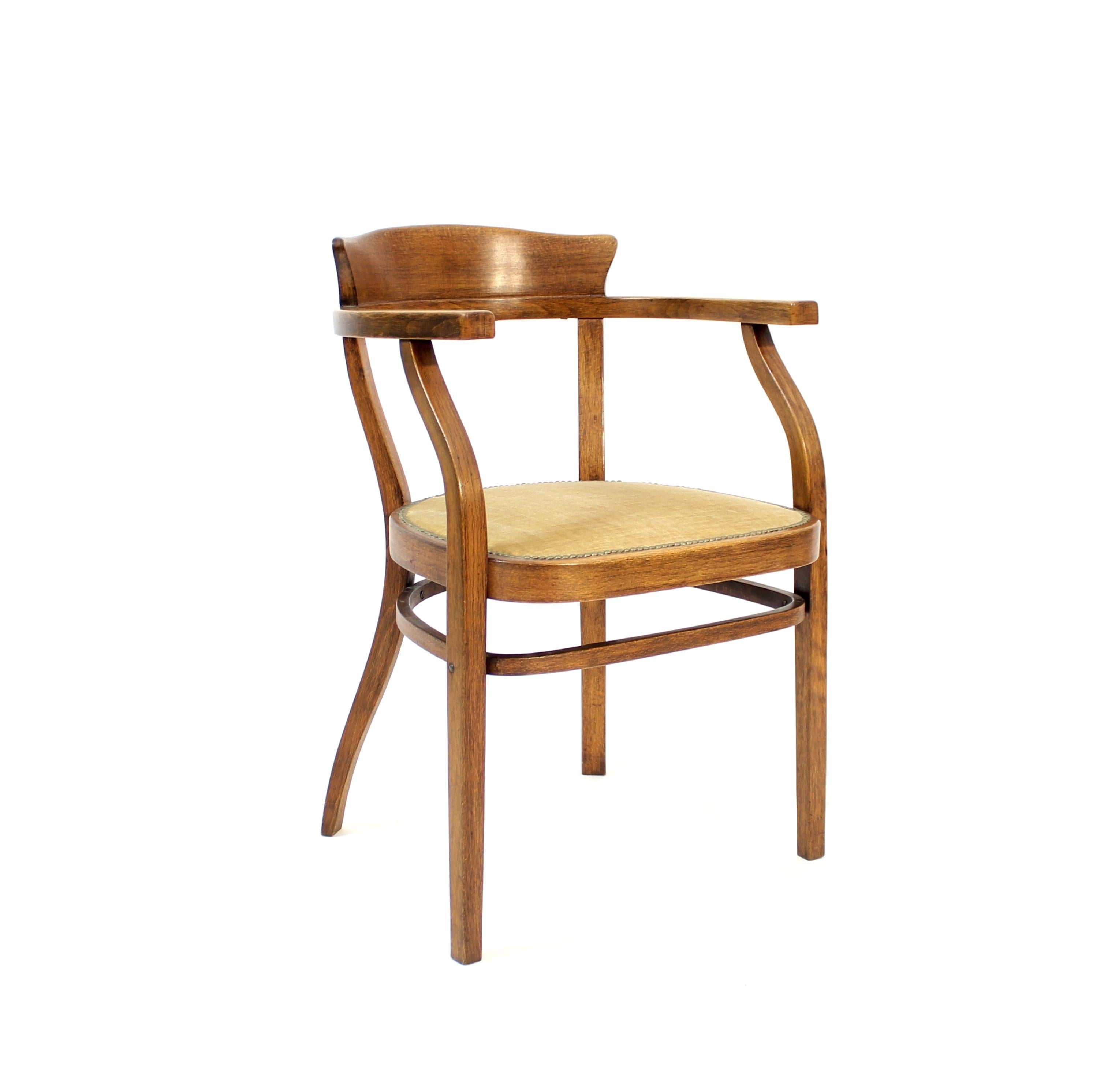 Bentwood armchair with velvet seat manufactured by Thonet in the early 20th century. Fabric on the seat is most likely original to the chair. Stamped and with original sticker by the manufacturer.  Good vintage condition with normal ware to the