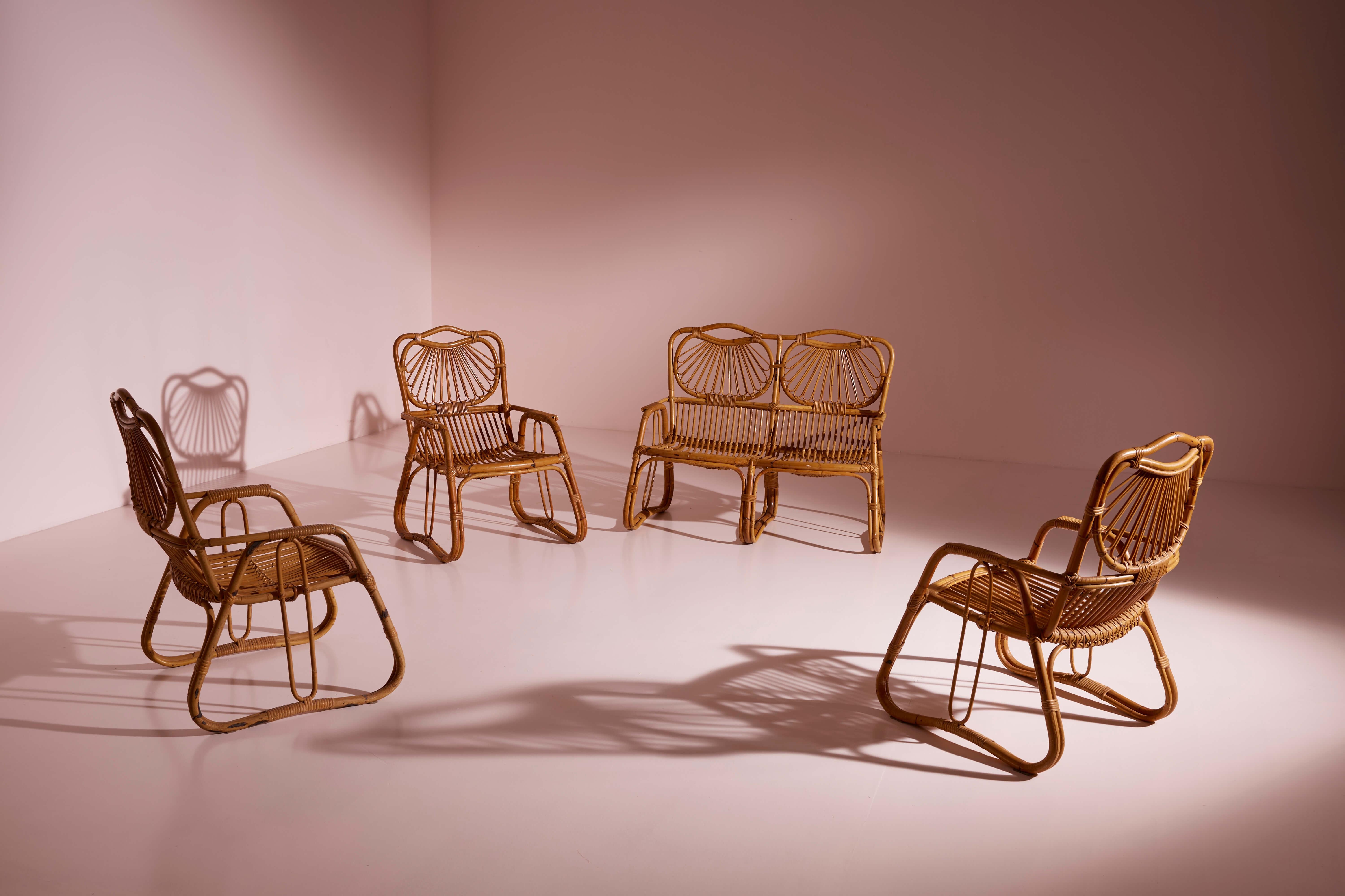 A two-seater sofa and three armchairs crafted from curved wicker and bamboo, this Italian-made living room set from the 1960s embodies timeless elegance and comfort.

Regardless of the weather outside, sitting in a wicker and rattan lounge set is