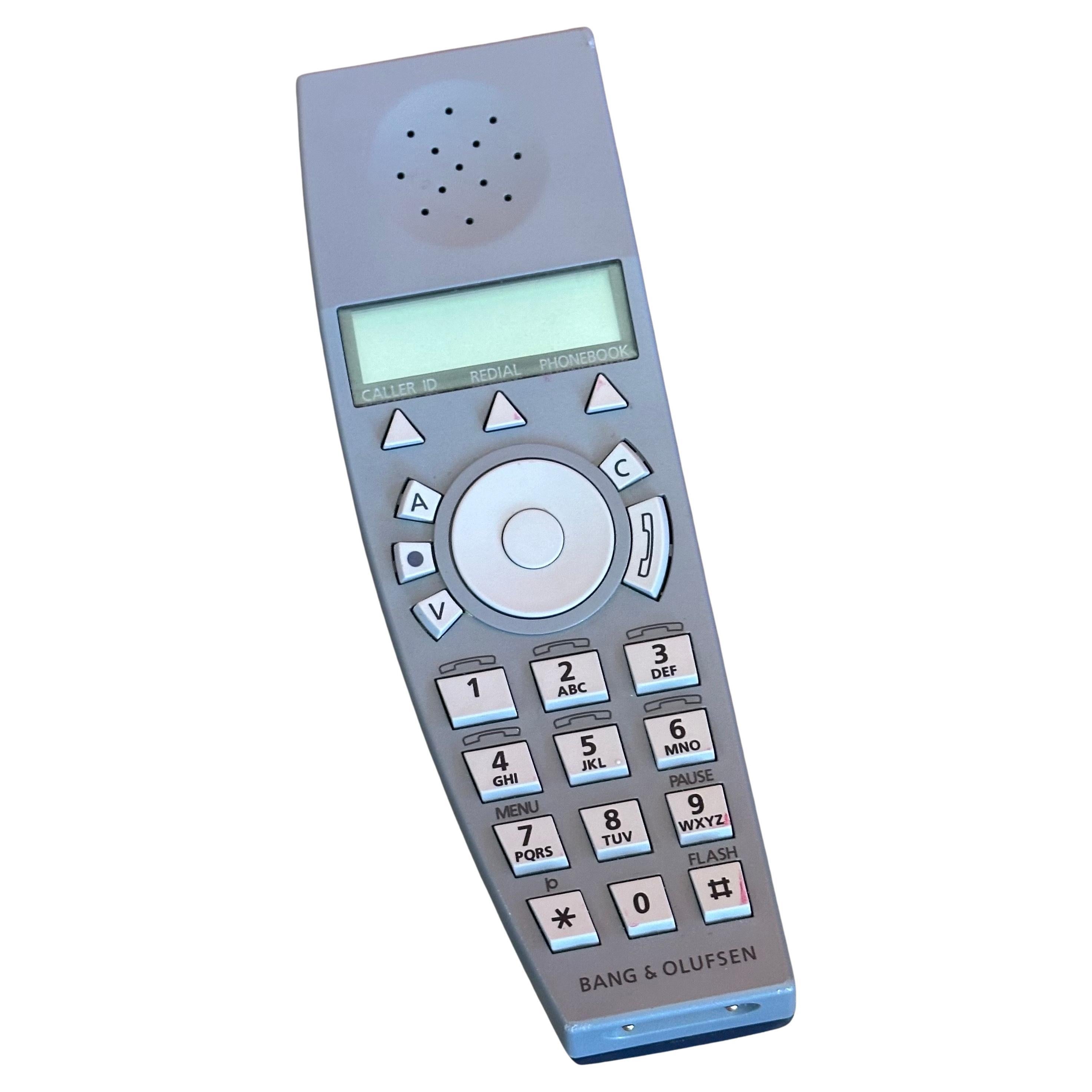 BeoCom 6000 cordless handset and table charger by Martin Iseli for Bang & Olufsen, circa 1990s.  The phone is navy blue and grey and has a black cradle / table charger; it is in very good working condition; it measures 4.75