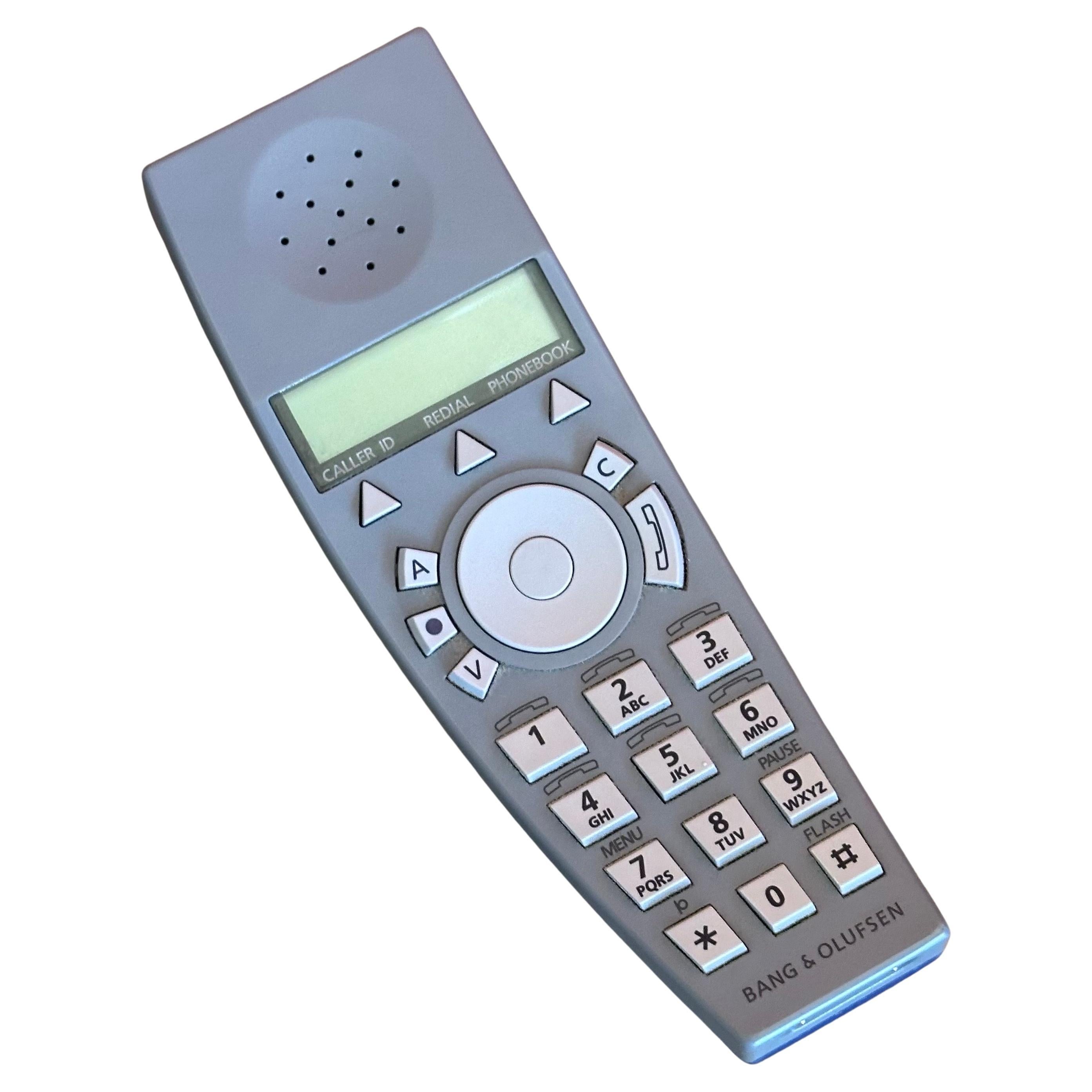 BeoCom 6000 cordless handset and table charger by Martin Iseli for Bang & Olufsen, circa 1990s.  The phone is royal blue and grey and has a grey cradle / table charger; it is in very good working condition; it measures 4.75