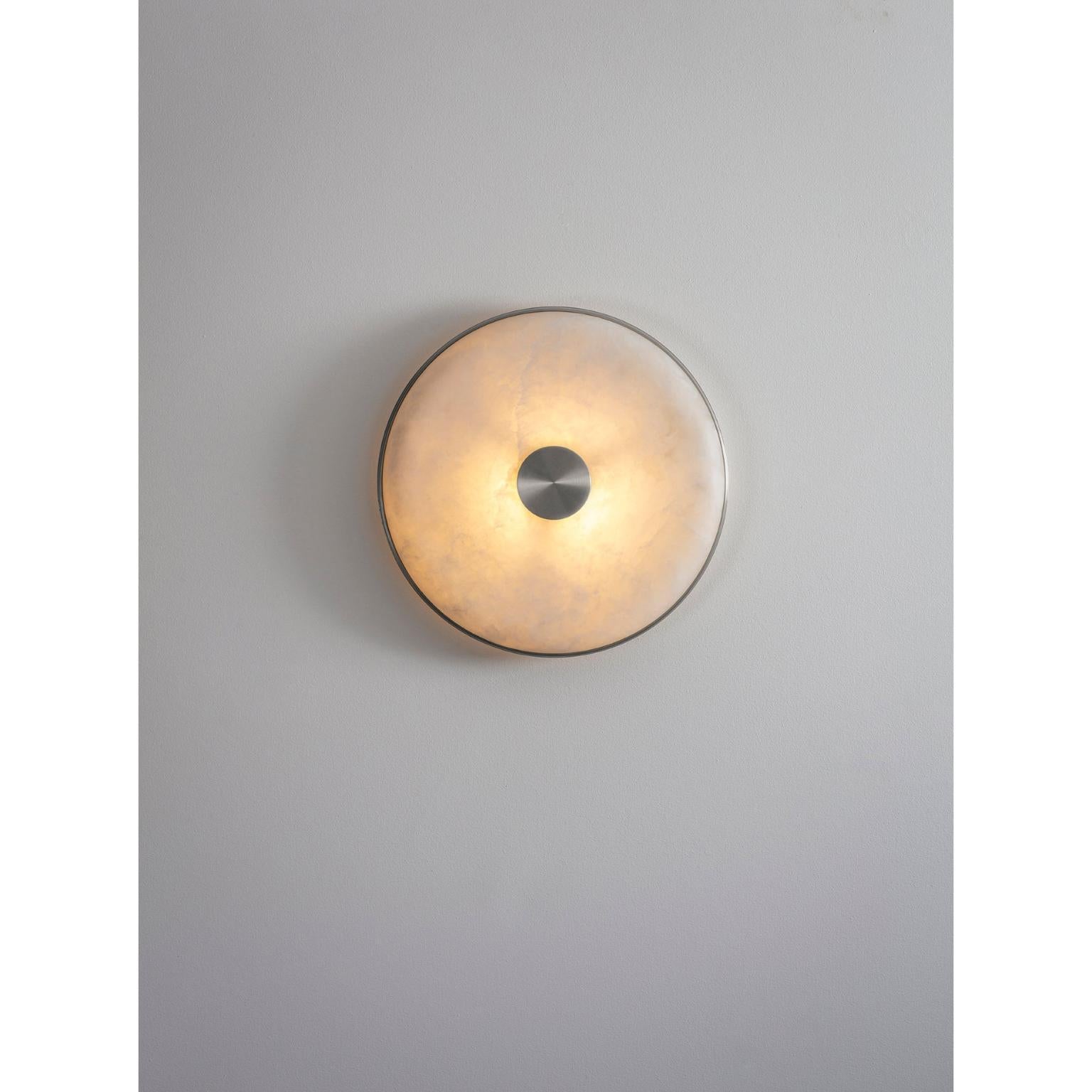 Beran Satin Nickel Large Wall Light by Bert Frank
Dimensions: D 6,5 x W 36 x H 36 cm.
Materials: Satin nickel and alabaster.

Available in two different sizes. Available in different finishes and materials. Please contact us. 

Simple and elegant in