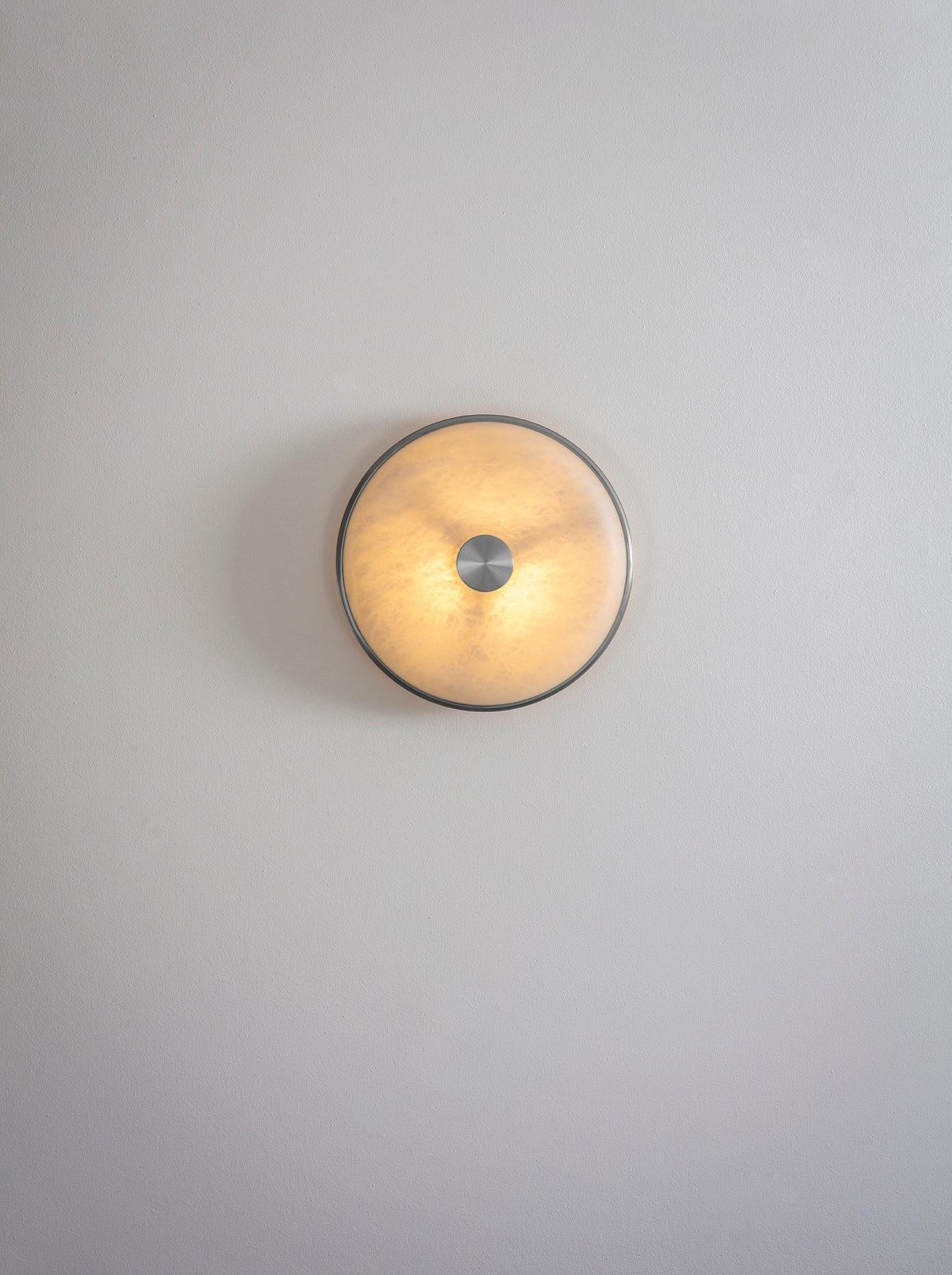 Beran Satin Nickel Small Wall Light by Bert Frank
Dimensions: D 6,5 x W 26 x H 26 cm.
Materials: Nickel and alabaster.

Available in two different sizes. Available in different finishes and materials. Please contact us. 

Simple and elegant in form,