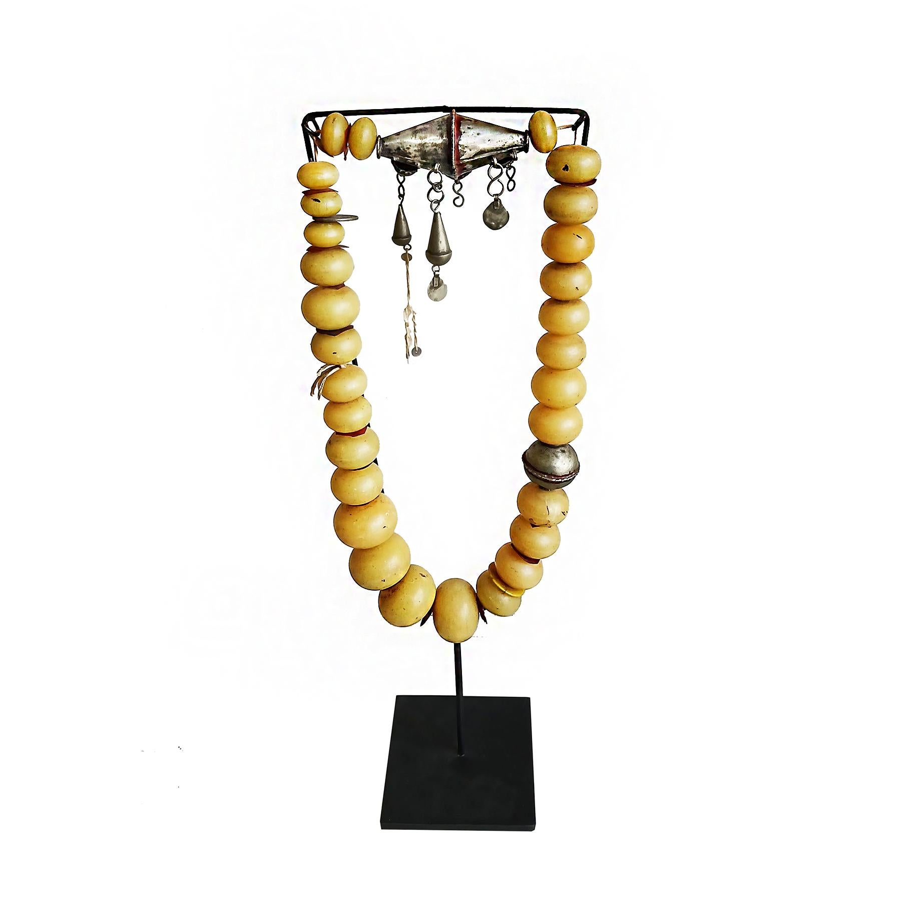 A long Berber necklace, hand-crafted with Copal amber large beads and silver accents. Morocco, early 20th Century. 

Copal amber is a tree resin similar to amber but not fully fossilized. While transparent amber is millions of years old, Copal