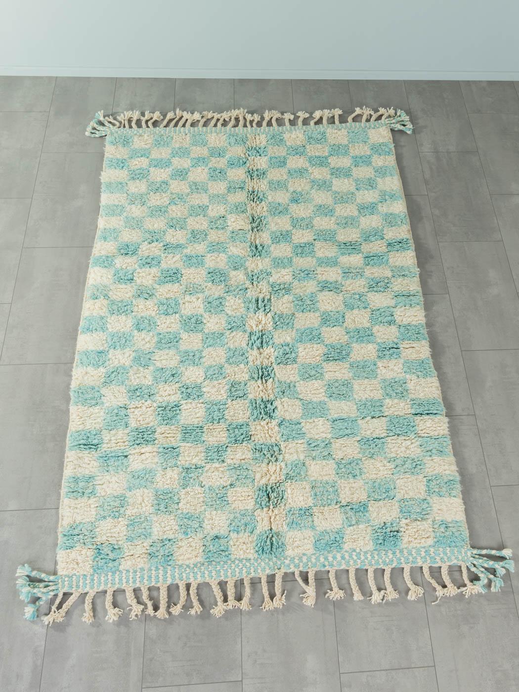 Skyblue Check is a contemporary 100% wool rug – thick and soft, comfortable underfoot. Our Berber rugs are handwoven and handknotted by Amazigh women in the Atlas Mountains. These communities have been crafting rugs for thousands of years. One knot