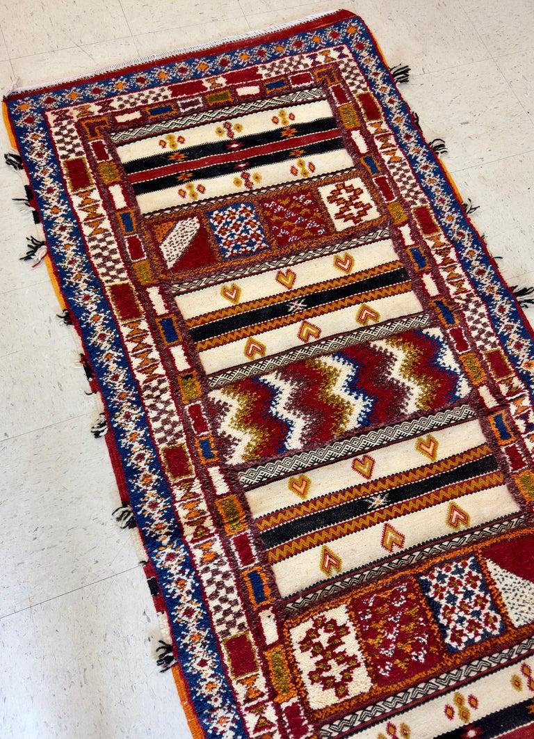 A Boho Chic Hmadwover Moroccan rectangular rug featuring deep earthy colors. . Transform any space in your home into a sophisticated and exclusive sanctuary with this premium tribal Berber rug hand-woven in Morocco. Made with the utmost care using