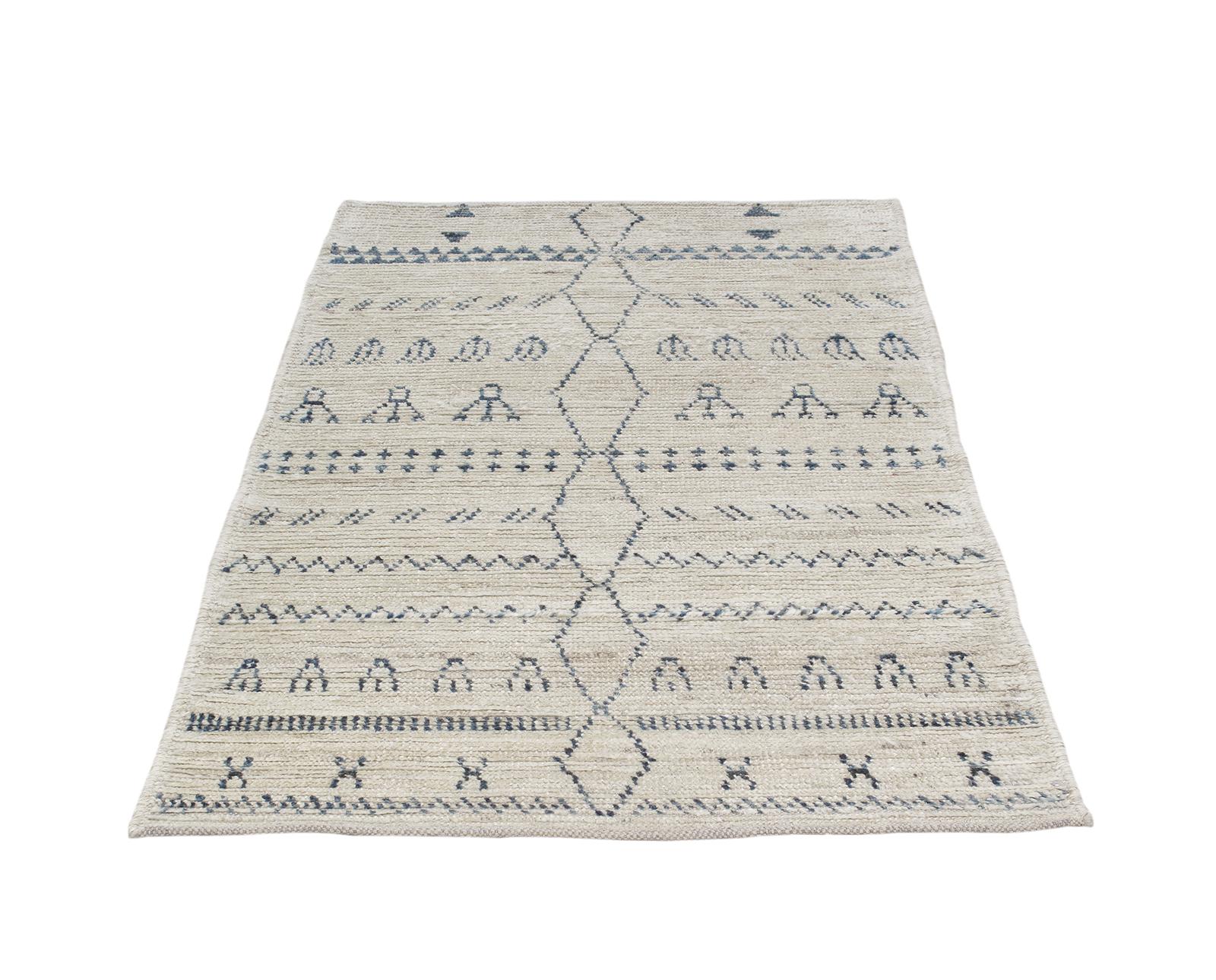 This rug resembles the Berber tribal rugs that have been made in Morocco for centuries in the Atlas Mountain region. Crafted with the same hand-carded, hand-spun wool, it is hand-knotted in a truly artistic organic pattern by local weavers in