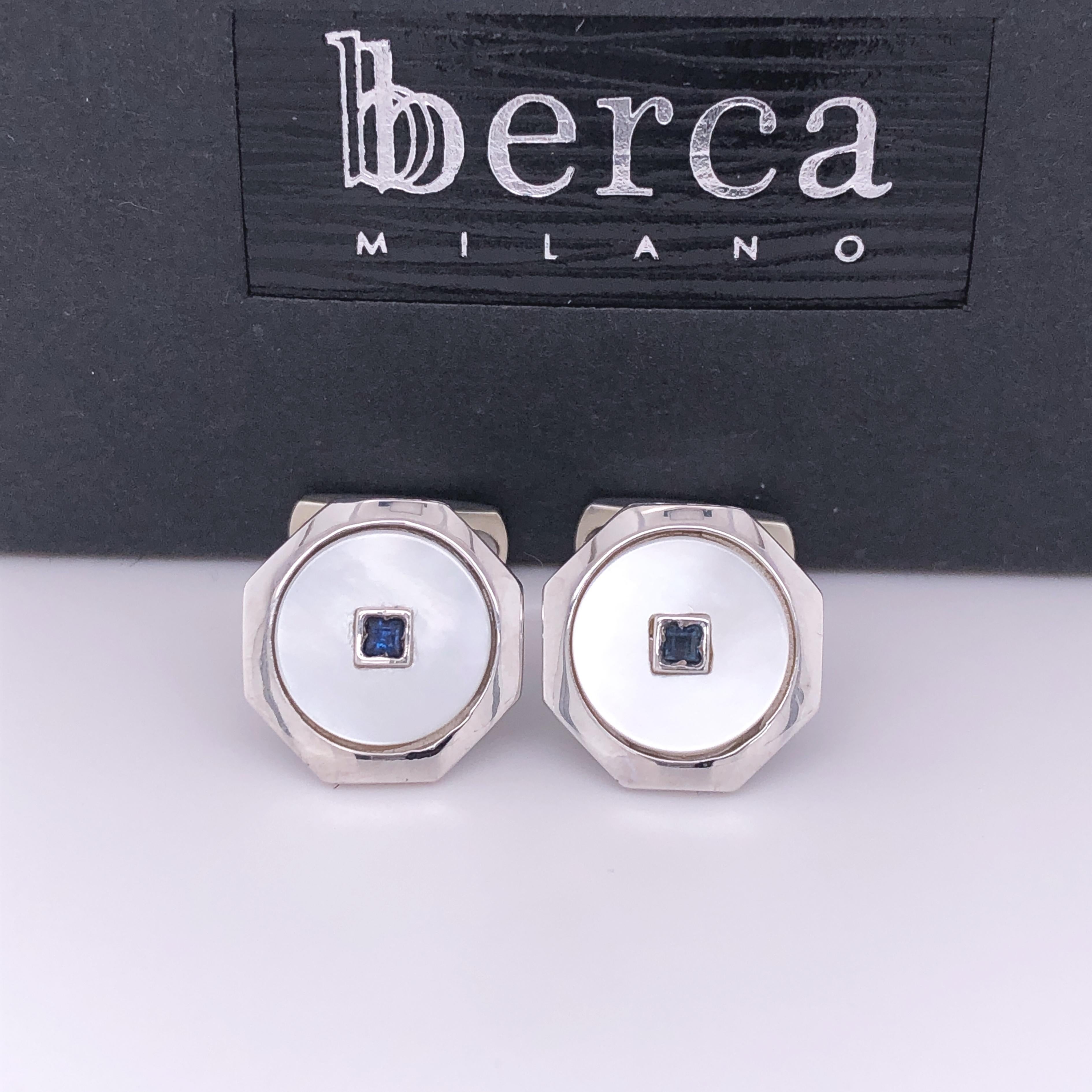 Absolutely Chic Yet Timeless 0.14 Carat Square Shaped Natural Blue Sapphire in a white round mother-of-pearl disk, white gold octagonal setting, t-bar back.

In our smart black box and pouch.