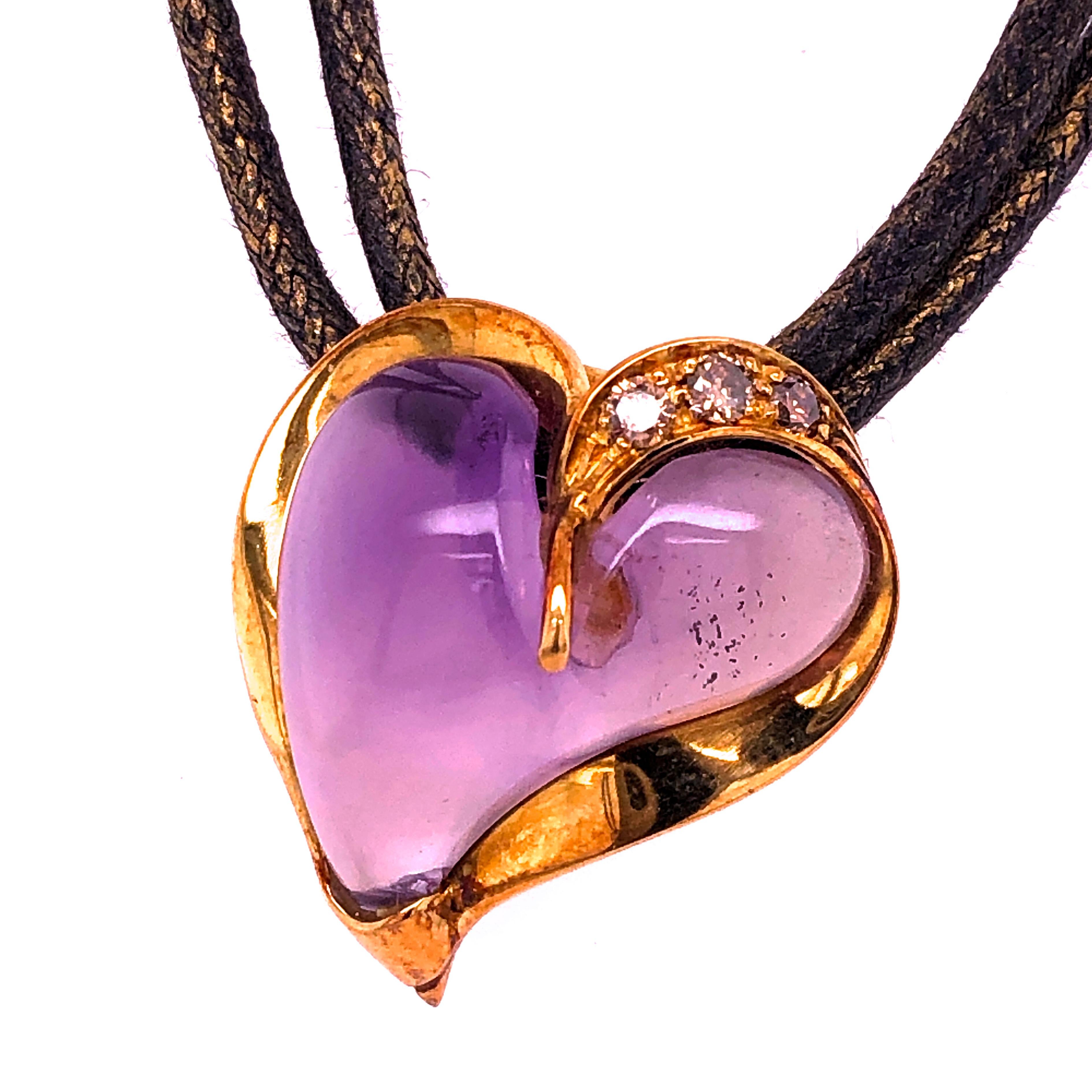 A Very Chic, Timeless, yet not traditional Heart Pendant featuring a 12Kt Natural Hand Inlaid Amethyst  Heart in a 0.24 Carat Champagne Diamond 18K Handcrafted Yellow Gold Setting. 
The 29.92 inches(76cm) 18Kt Gold Clasp Golden Brown Leather Long